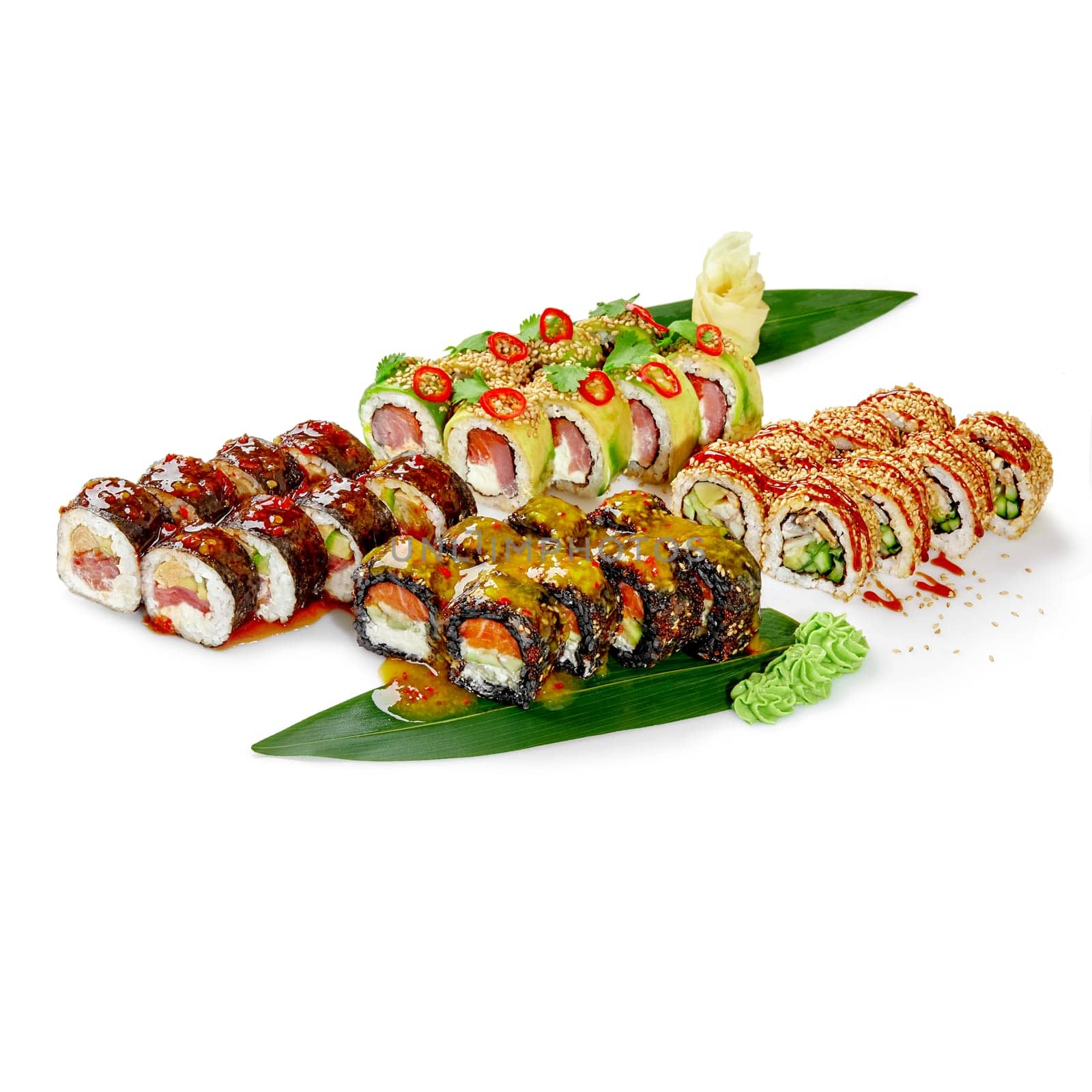 Vibrant assortment of sushi rolls with tuna, eel and salmon topped with spicy sauces, caviar, and fresh herbs, arranged on bamboo leaves, garnished with wasabi and ginger, isolated on white