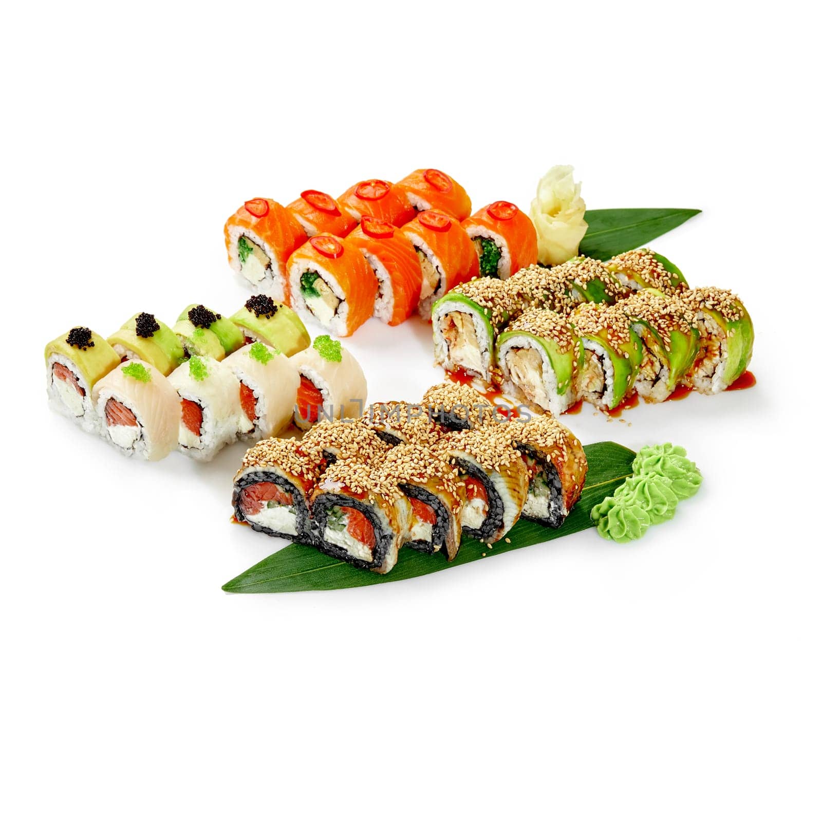 Elegant colorful assortment of Japanese sushi rolls with salmon, eel and perch, topped with sesame seeds and tobiko, presented on bamboo leaves garnished with wasabi and pickled ginger