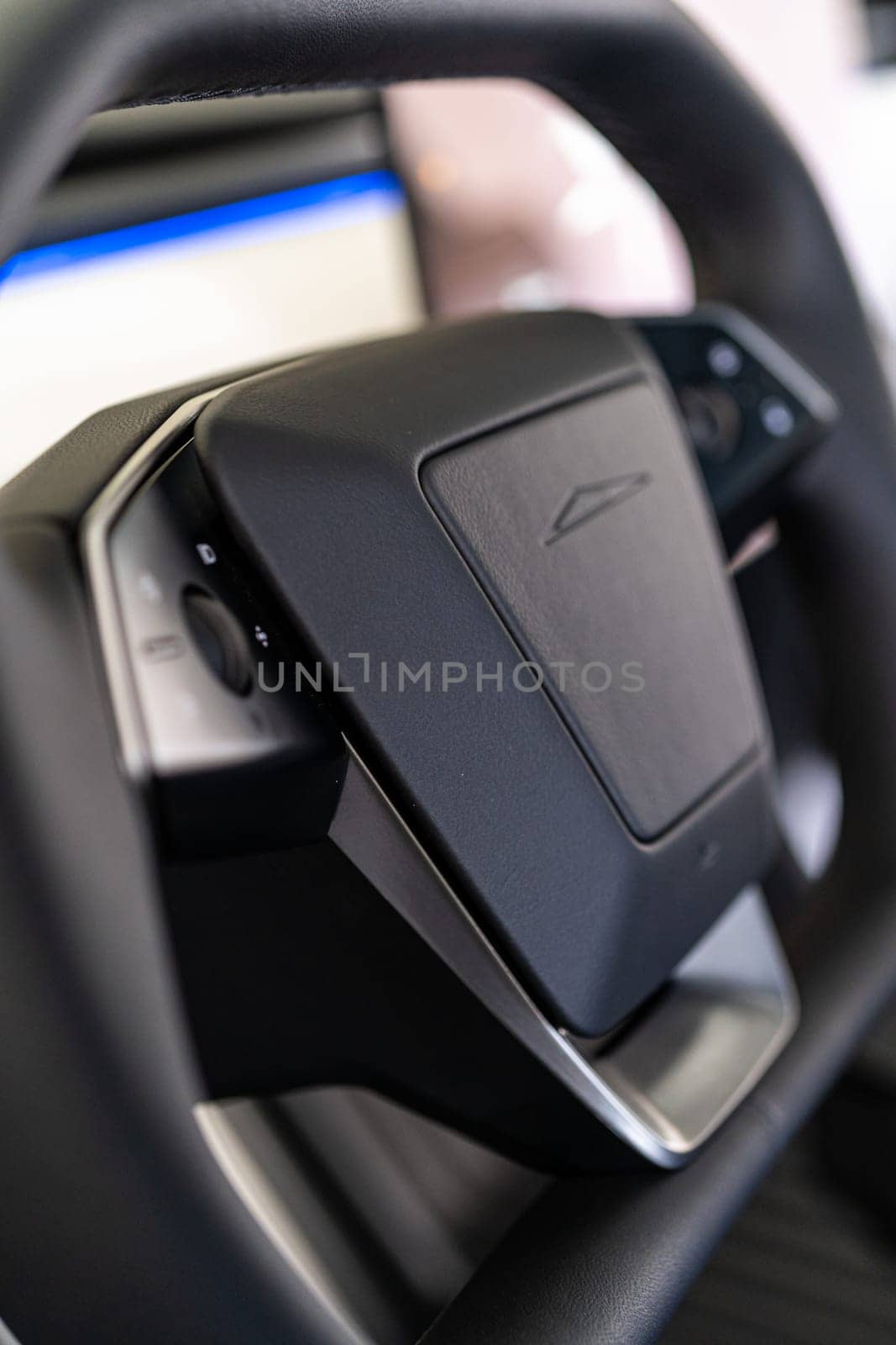 Denver, Colorado, USA-May 5, 2024-This image features a detailed close-up of the unique, minimalist steering wheel design of a Tesla Cybertruck, highlighting its sleek controls and futuristic aesthetic typical of Tesla innovative approach to vehicle design.