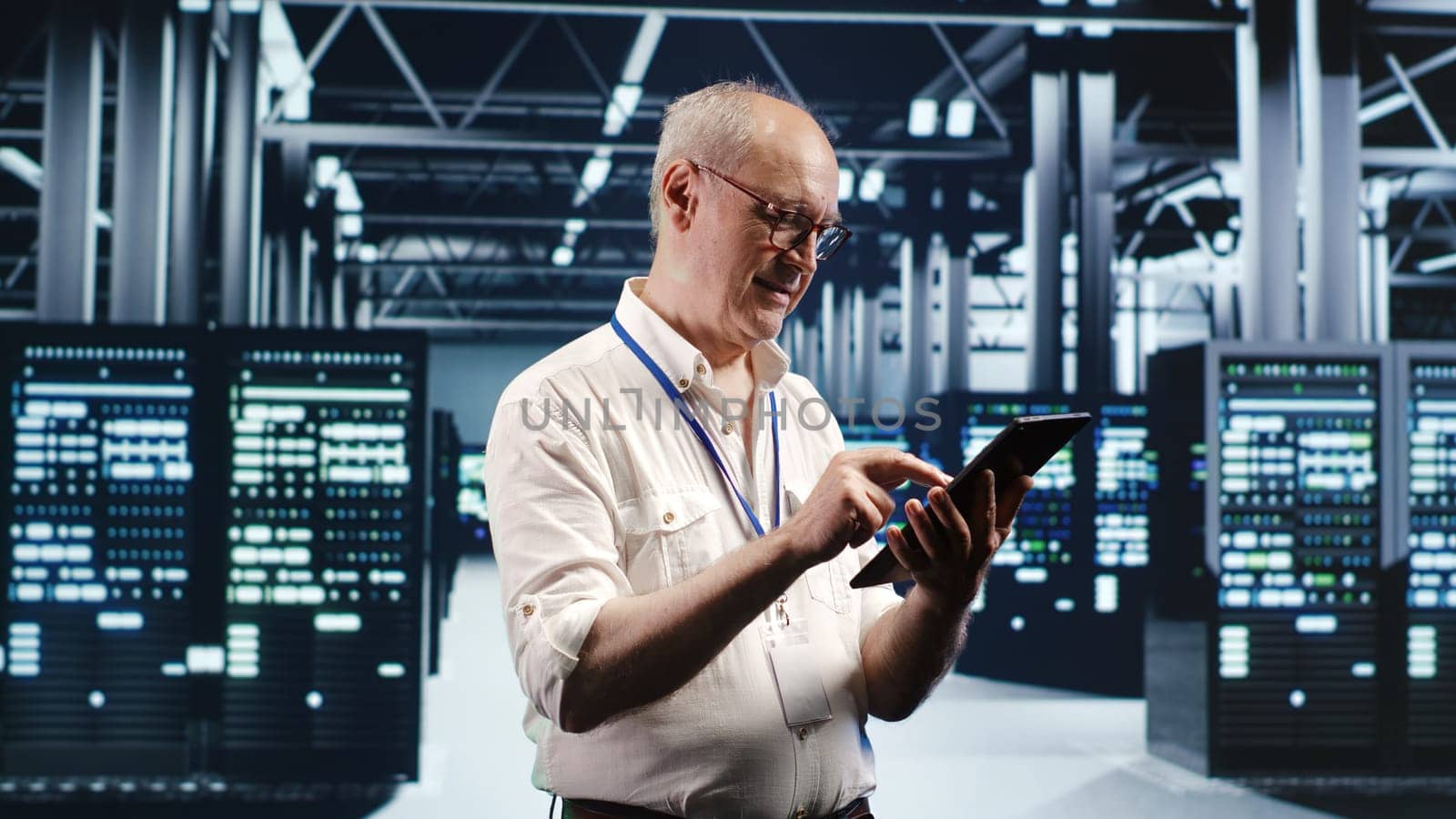 Older professional navigating network of server rigs in industrial cloud computing business. Worker with tablet doing scans and optimizations in high tech data center, preventing system worries
