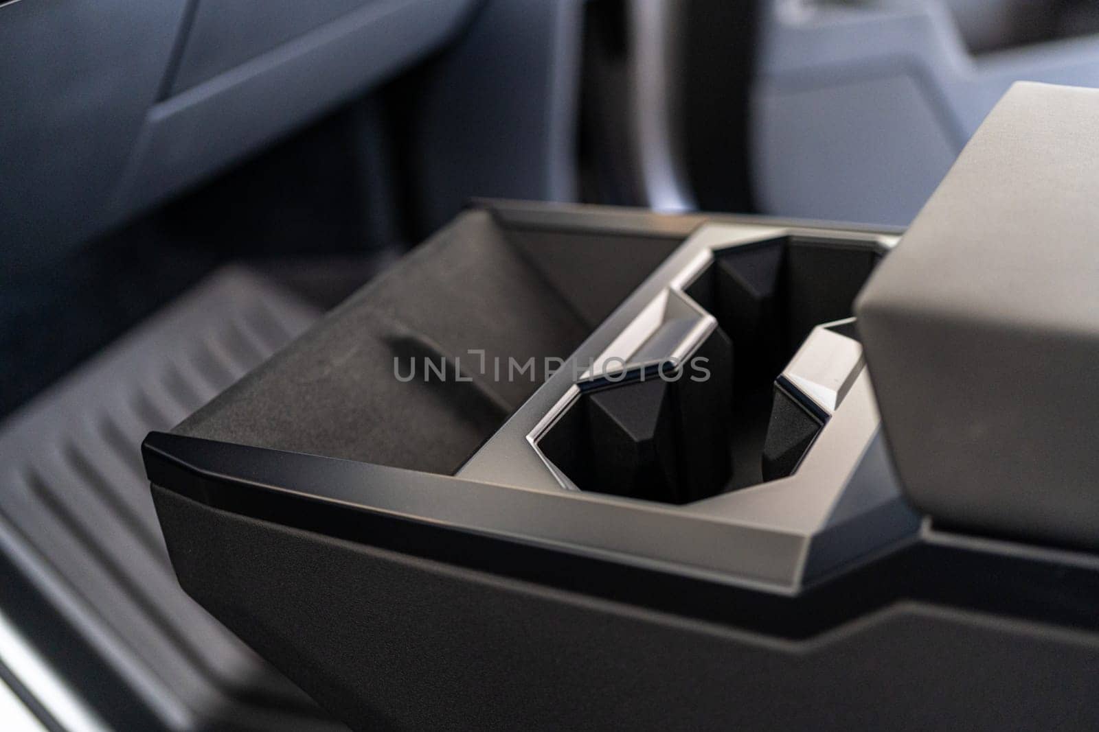 Denver, Colorado, USA-May 5, 2024-This image captures the innovative design of the cupholder inside the Tesla Cybertruck, showcasing its unique angular shapes and modern, minimalist aesthetic.