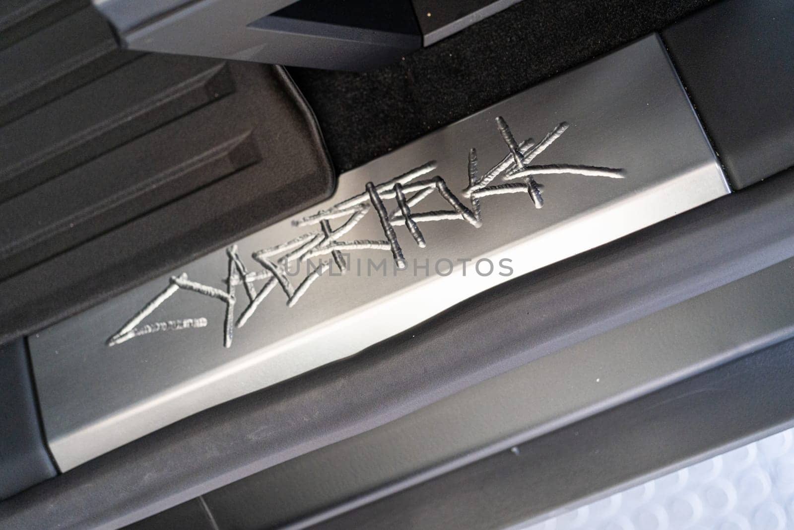 Denver, Colorado, USA-May 5, 2024-This image showcases the distinctive metal engraving of the Cybertruck logo on the interior of a Tesla Cybertruck, highlighting the vehicle unique branding elements and detailed craftsmanship.