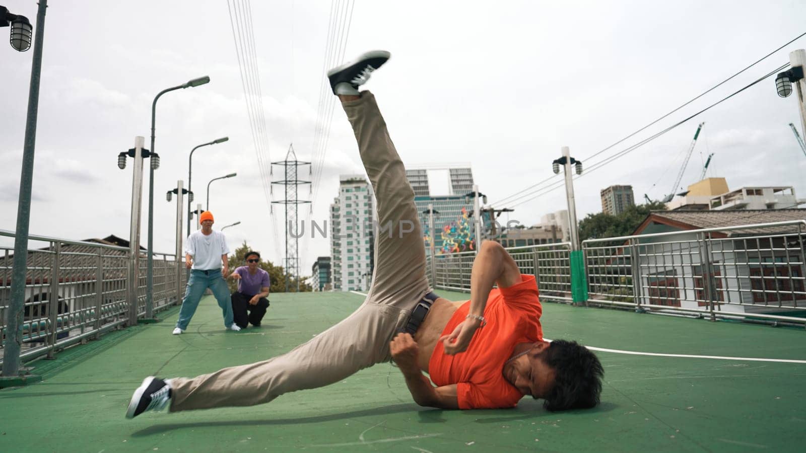 Young happy hipster perform break dancing or foot step with friend. Sprightly. by biancoblue