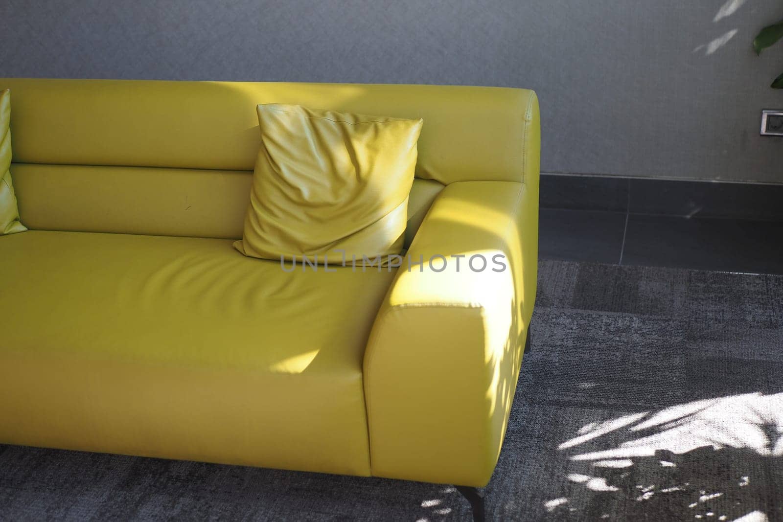 modern yellow sofa with pillows in living room at home by towfiq007