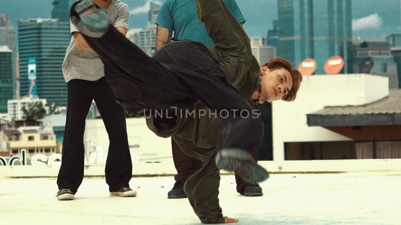 Professional asian break dancer practice B boy dance while multicultural friends at rooftop. Young modern dancing group doing hip hop movement. Style,fashion,action. Outdoor sport 2024. Endeavor.