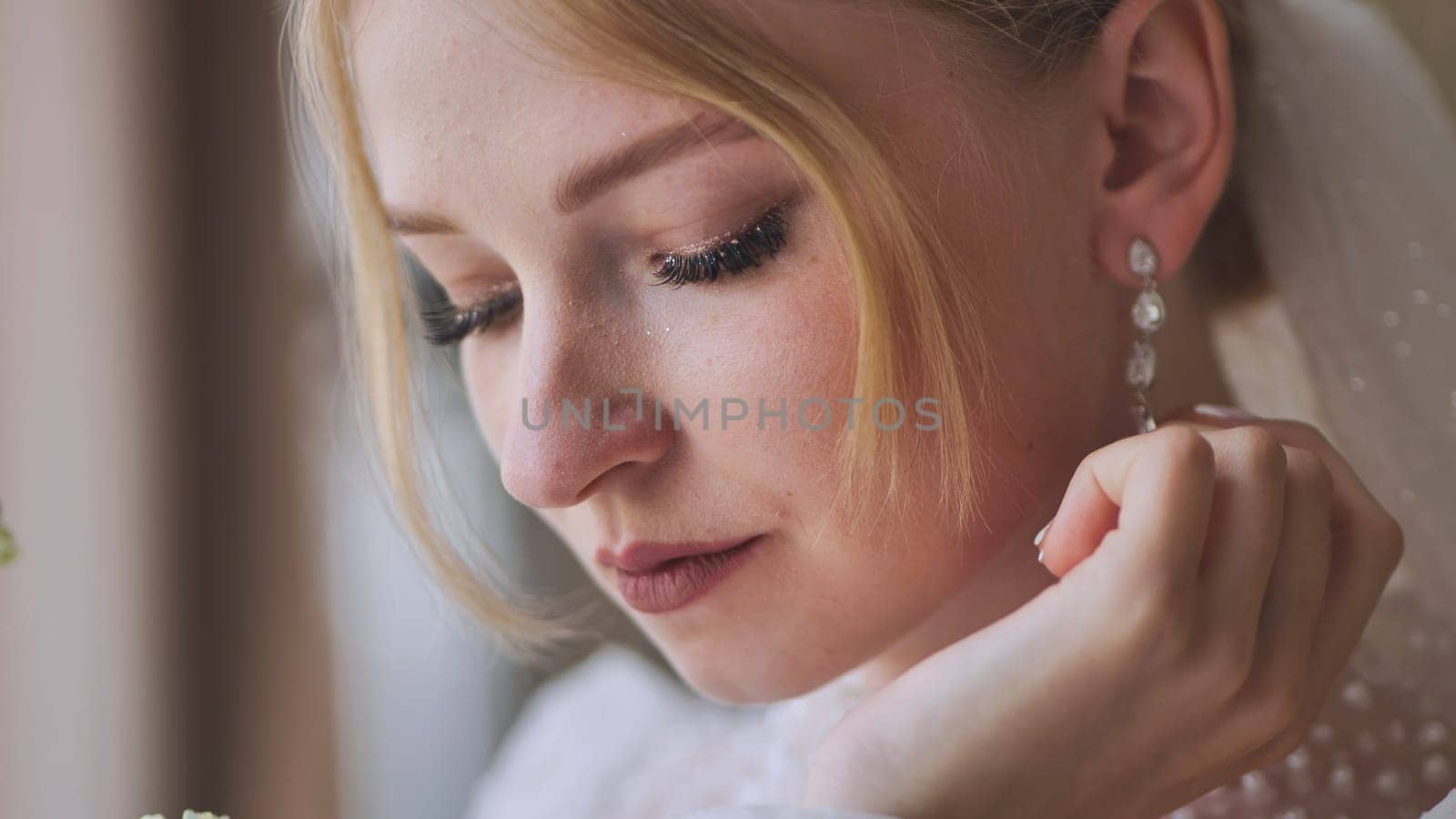 The bride corrects her earring. by DovidPro
