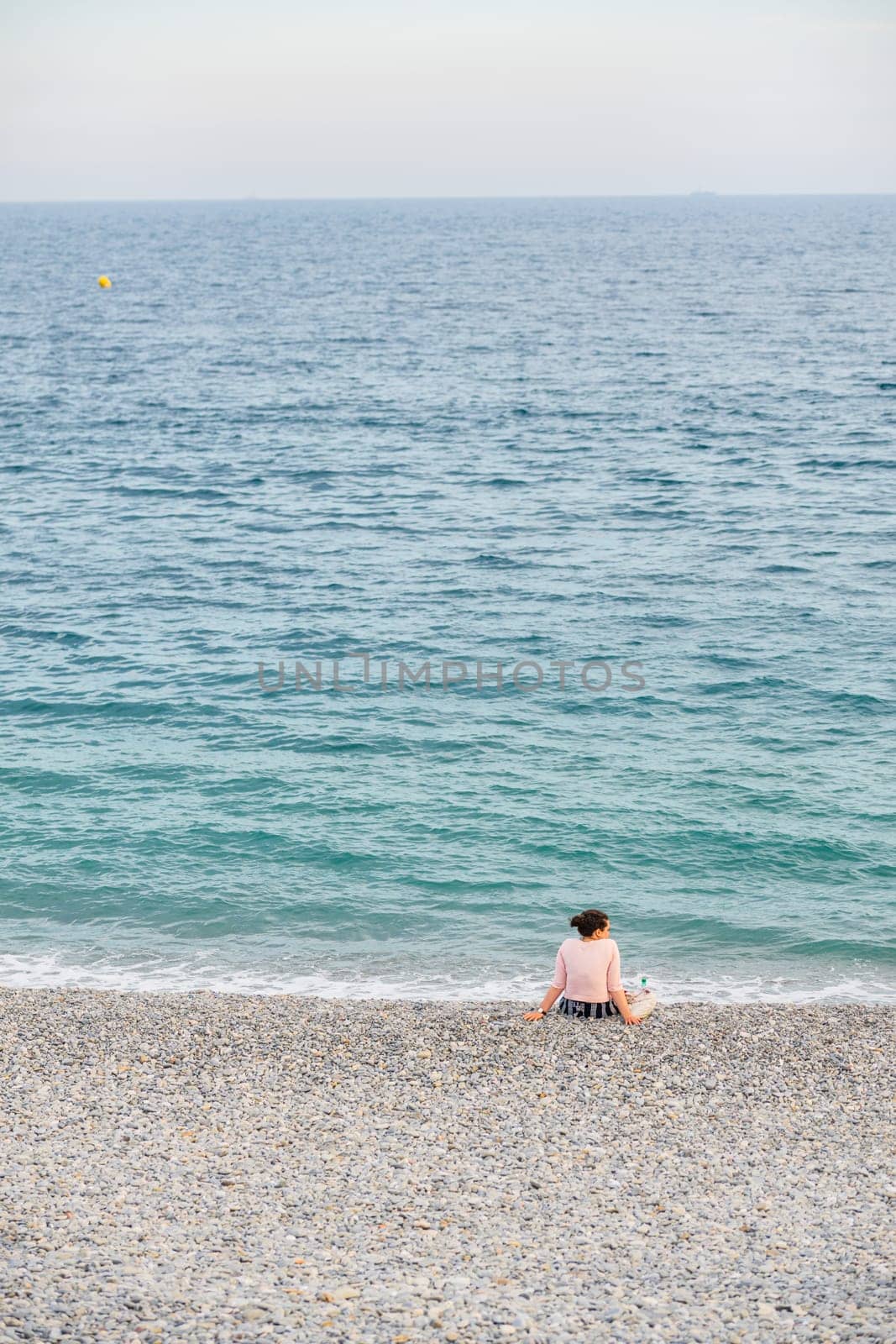 Woman at the beach in Nice, France, near the Promenade des Anglais