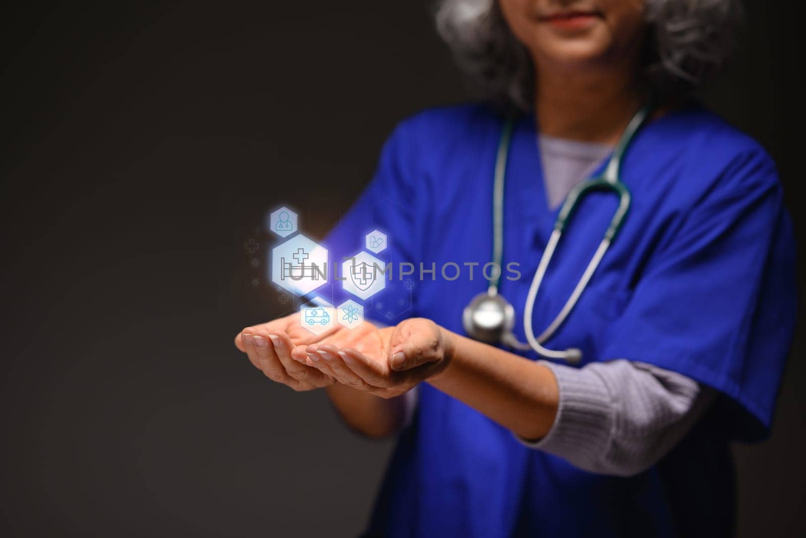 Modern medical icons over senior doctor hands. Medical innovative technology concept.