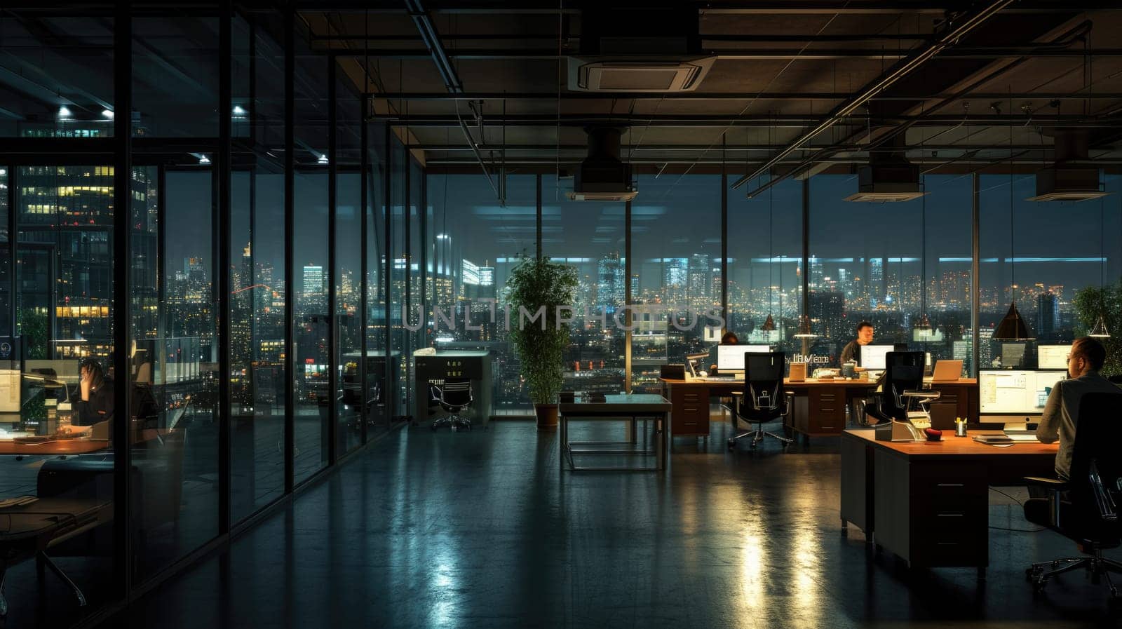 A gathering of individuals occupies office desks in a building during nighttime. The room features water fixtures, tables, and glass elements. AIG41