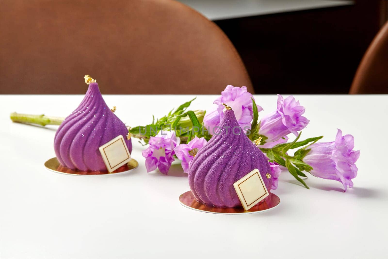 Luxurious purple mousse desserts with gold leaf and flowers by nazarovsergey