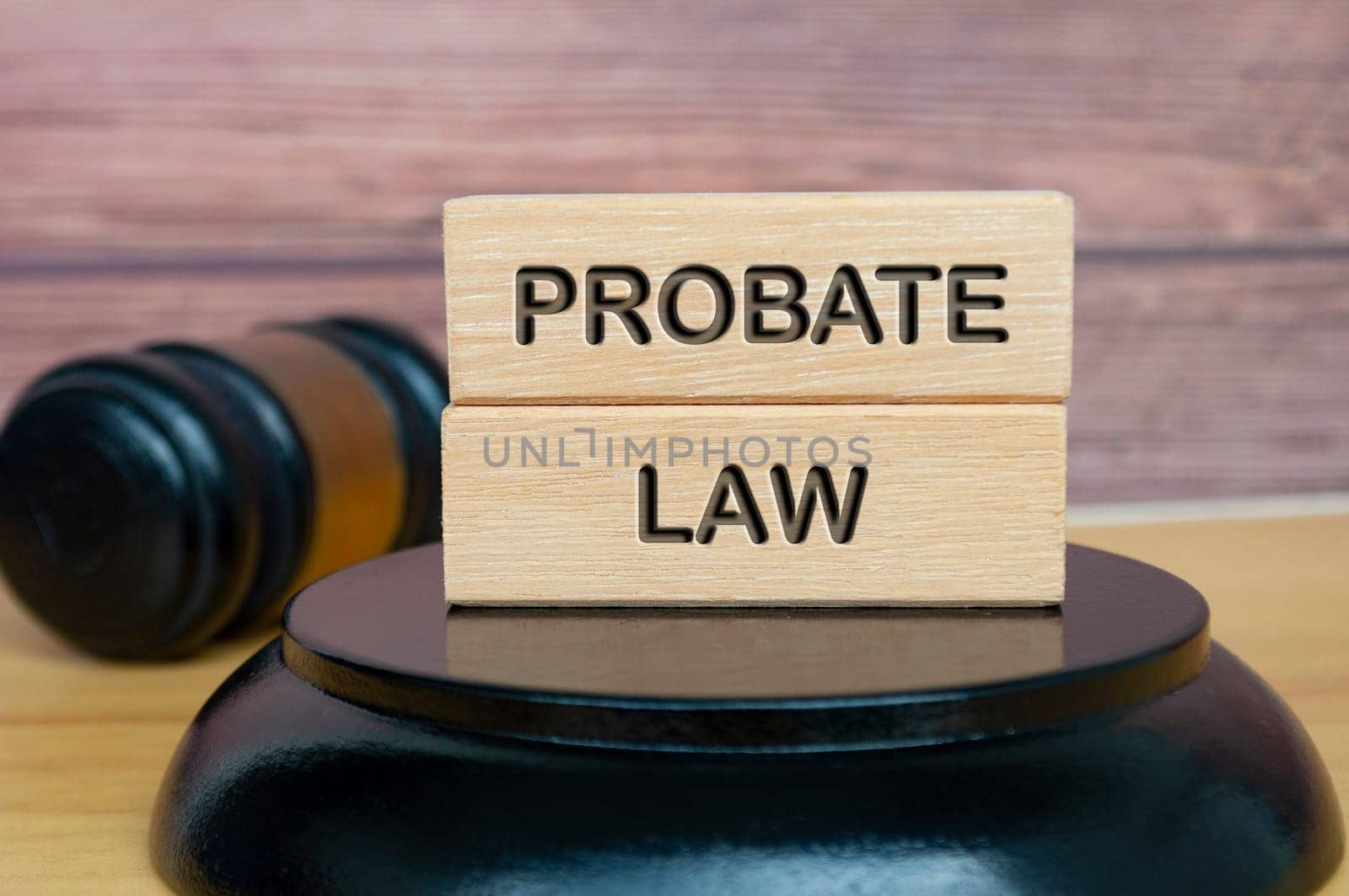 Probate law text engraved on wooden block with gavel background. Legal and law concept. by yom98