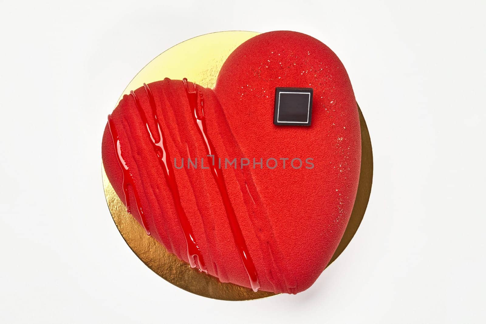 Velvety red heart-shaped mousse cake on gold cardboard by nazarovsergey