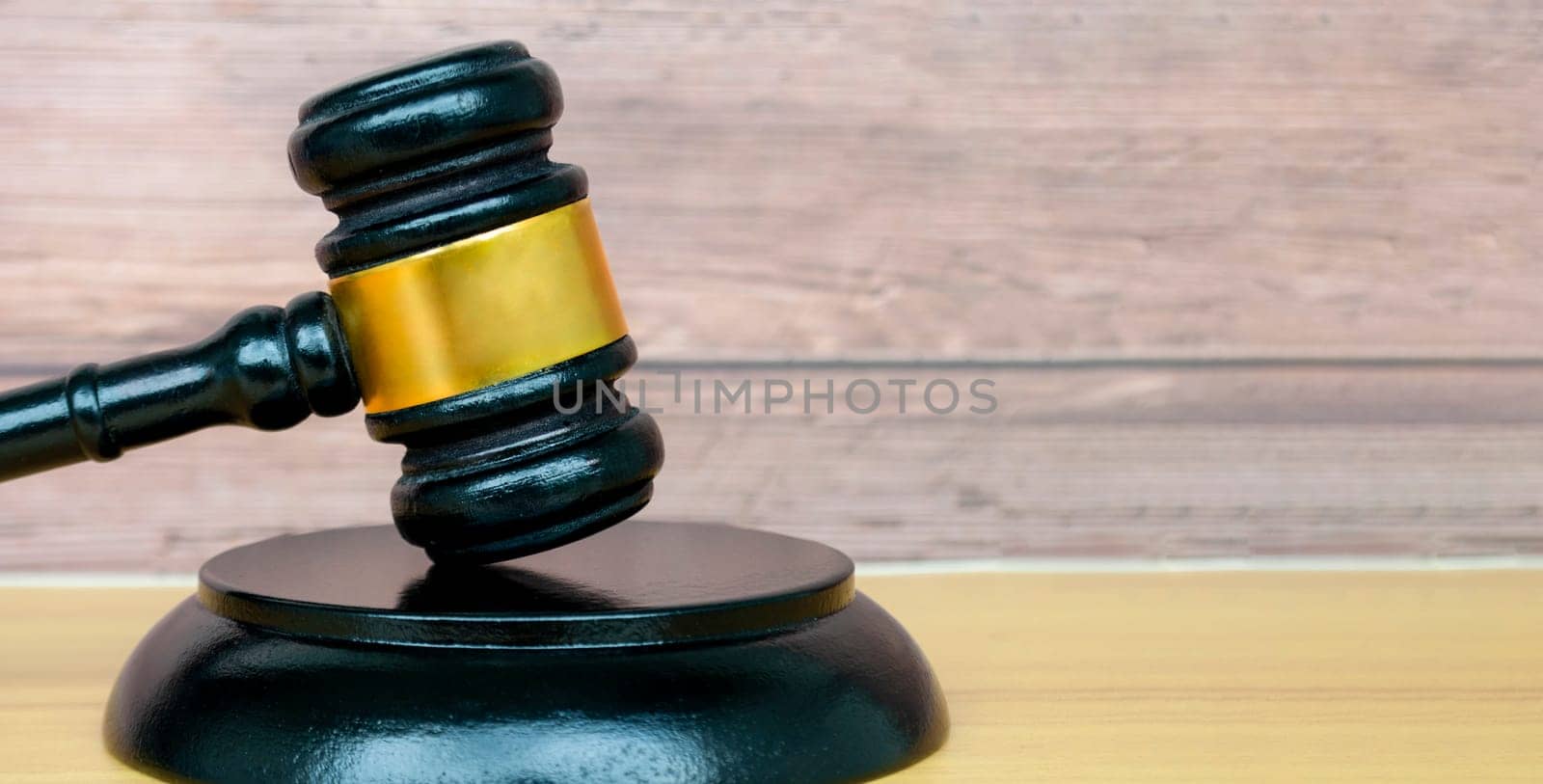 Gavel on wooden background with customizable space for text or law matters. Law concept