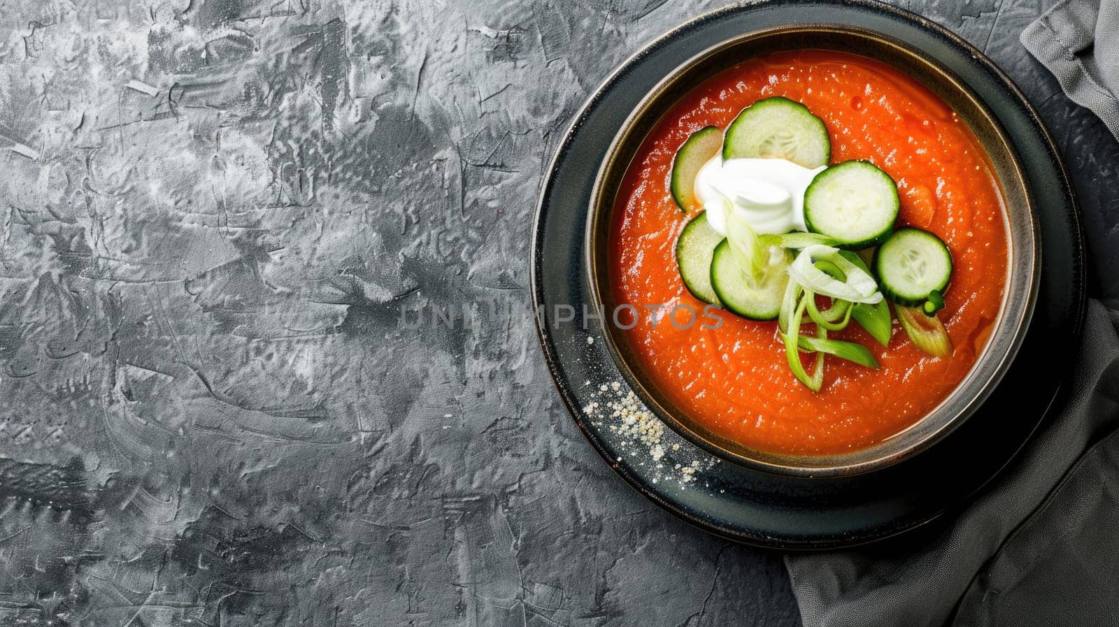 An artistic illustration of a bowl of tomato soup with cucumbers and sour cream, placed on a blue rectangle background, surrounded by electronic devices and automotive lighting AIG50