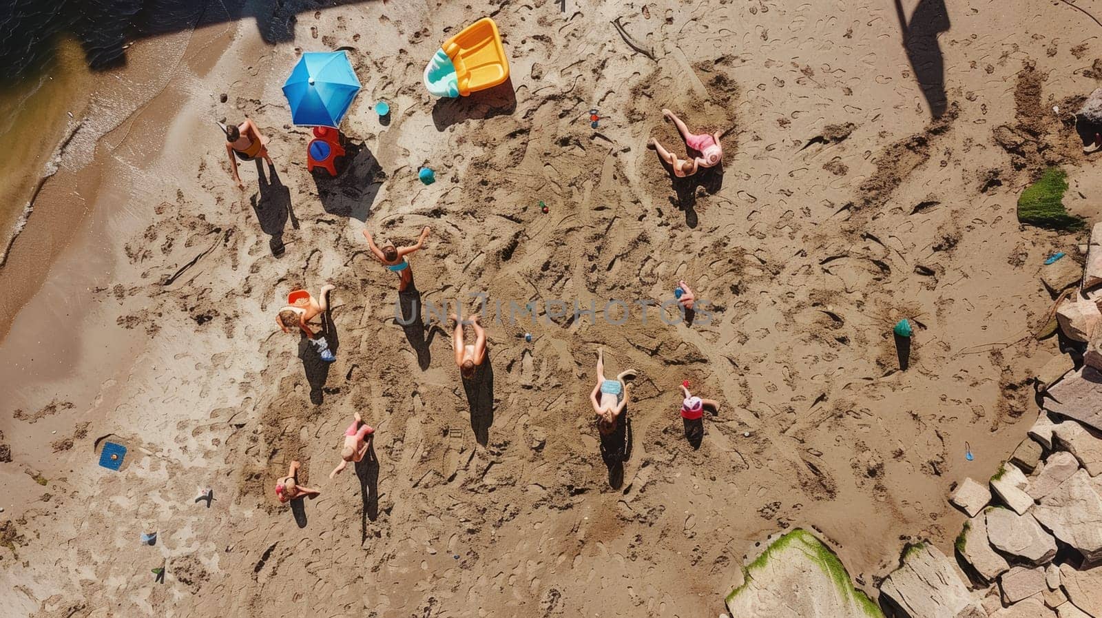 A group of children are leisurely playing in the sand on a beach, creating art and exploring the rock landscape. The beach offers a perfect setting for recreation and adventure AIG50