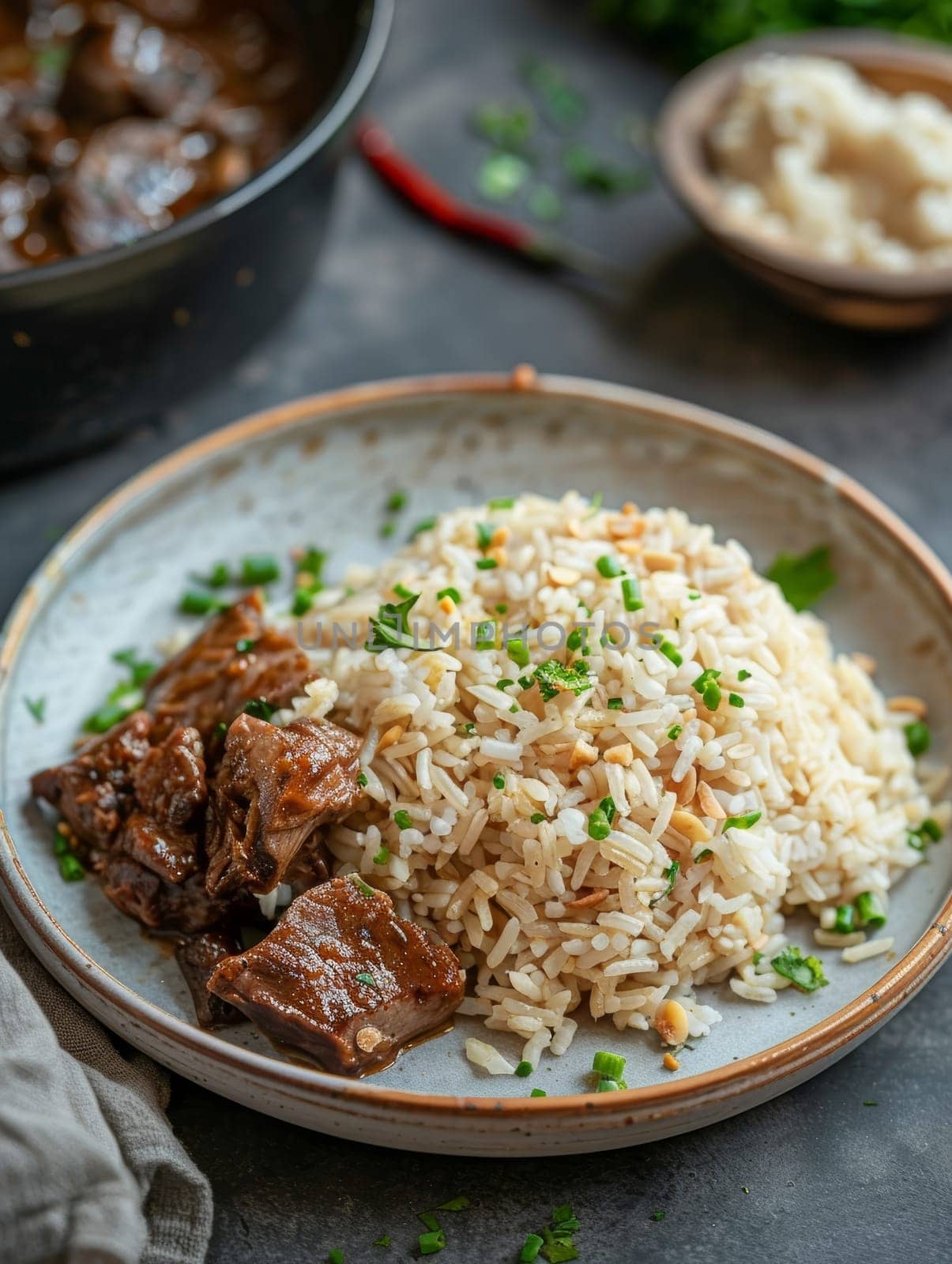 Zimbabwean peanut butter rice, a traditional dish cooked with peanut butter and served with a hearty meat stew, presented on a plate. by sfinks
