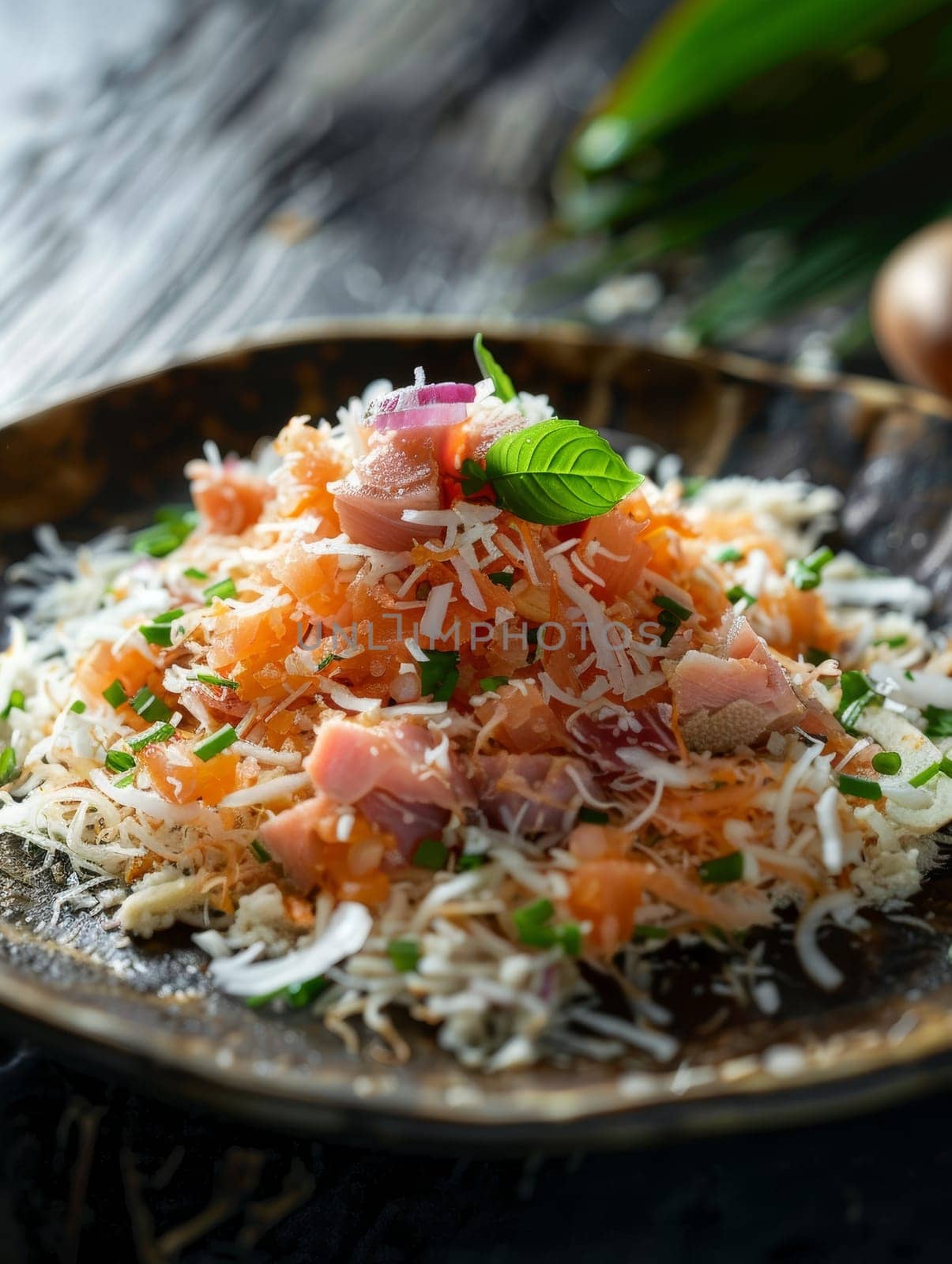 Maldivian mas huni, shredded smoked tuna mixed with coconut and onions, served on a small plate. A traditional and flavorful dish from the Maldives