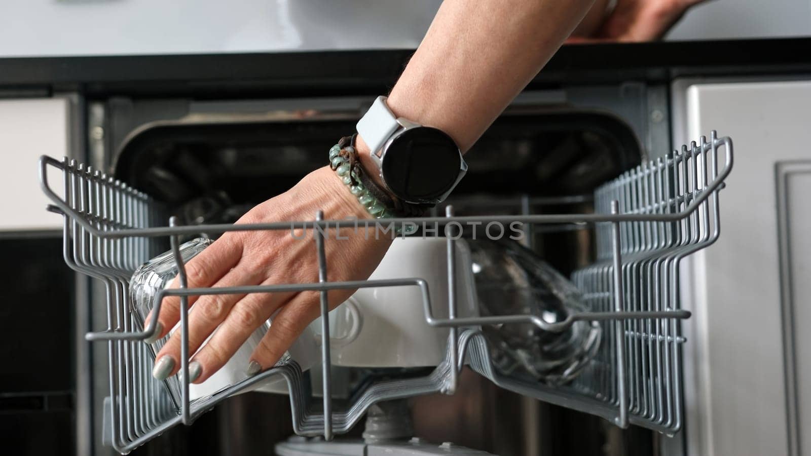 Girl Takes Clean Plate From Dishwasher by tan4ikk1
