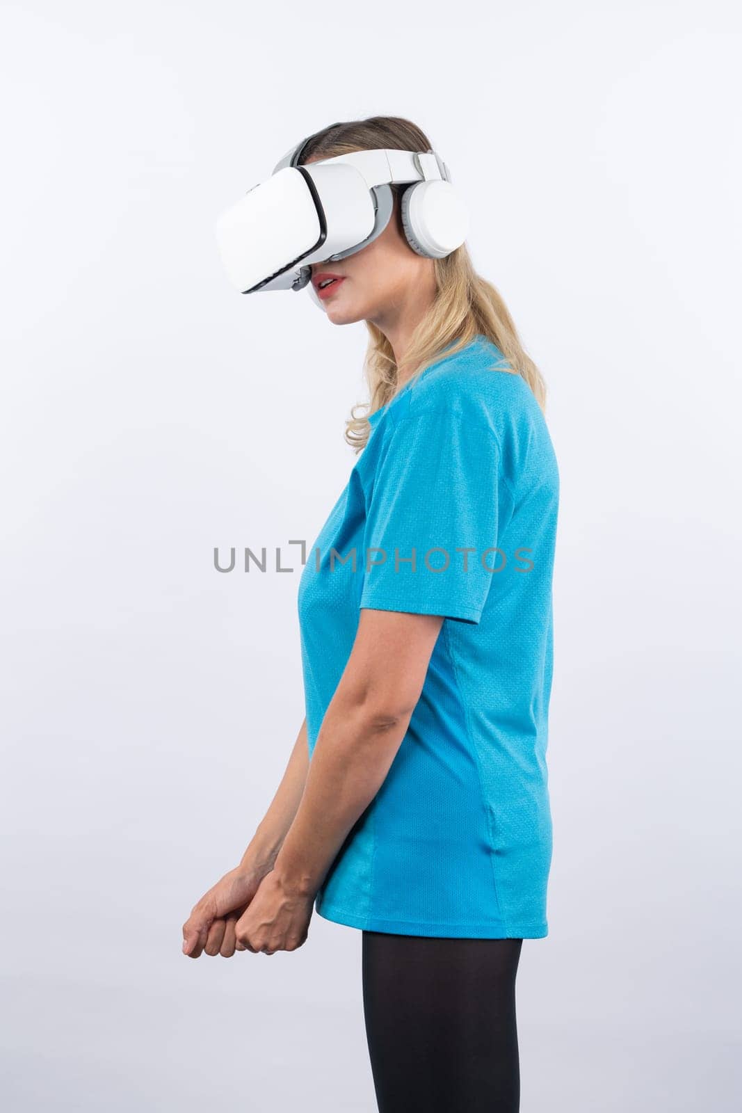 Caucasian girl playing golf and moving gesture by using VR glasses. Contraption. by biancoblue