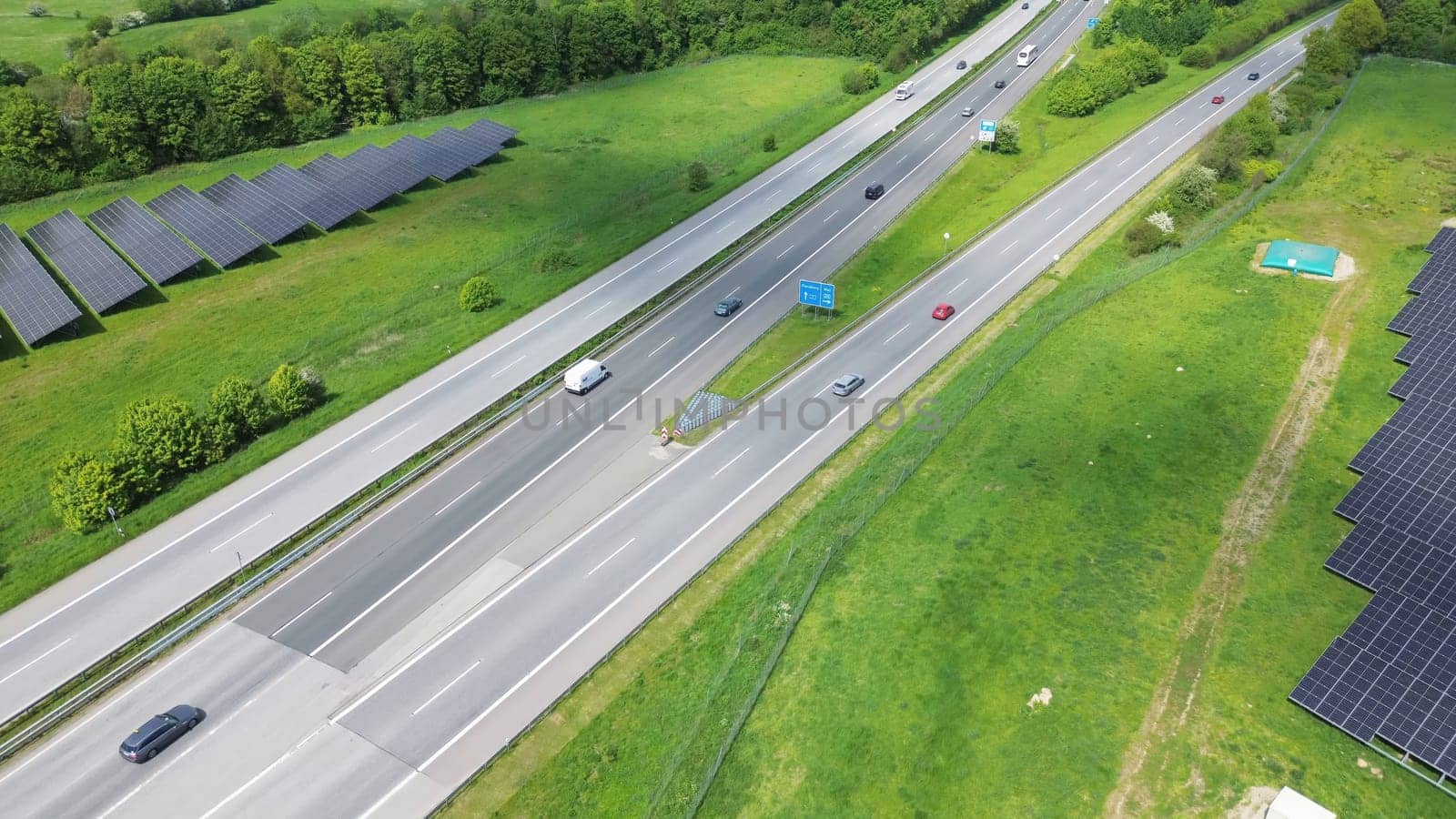 Drone view of a highway in Germany with a lot of traffic and many green fields around it. by MP_foto71