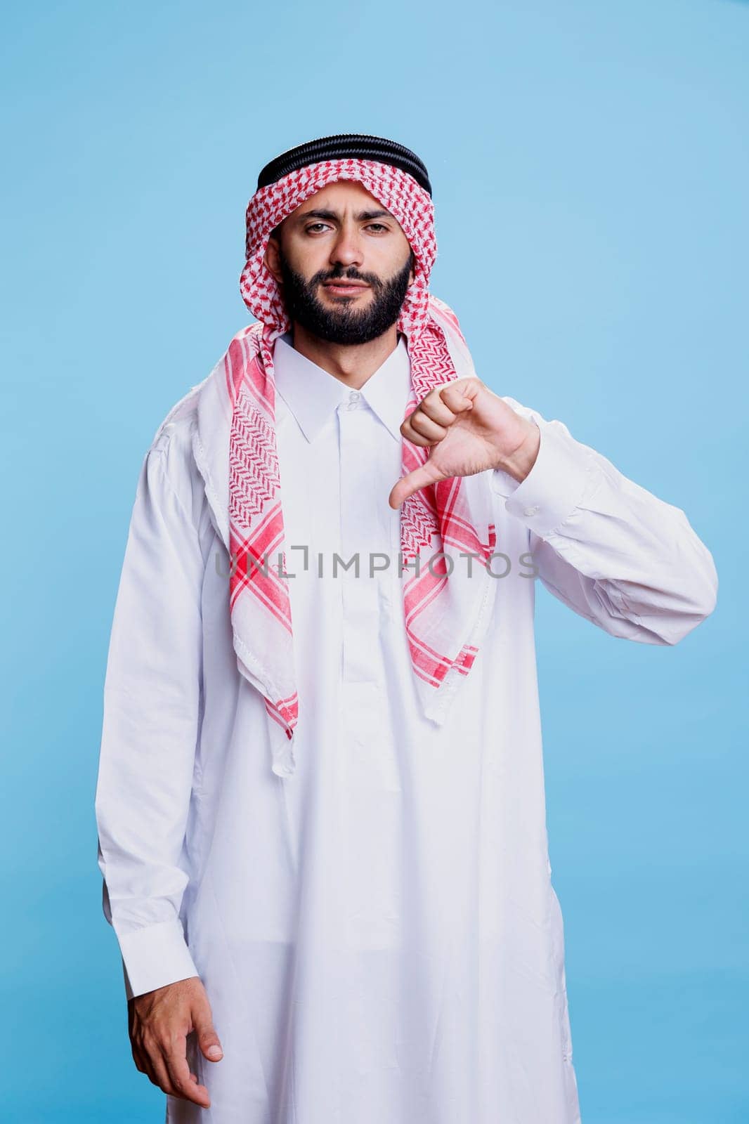 Muslim man in thobe with thumb down by DCStudio
