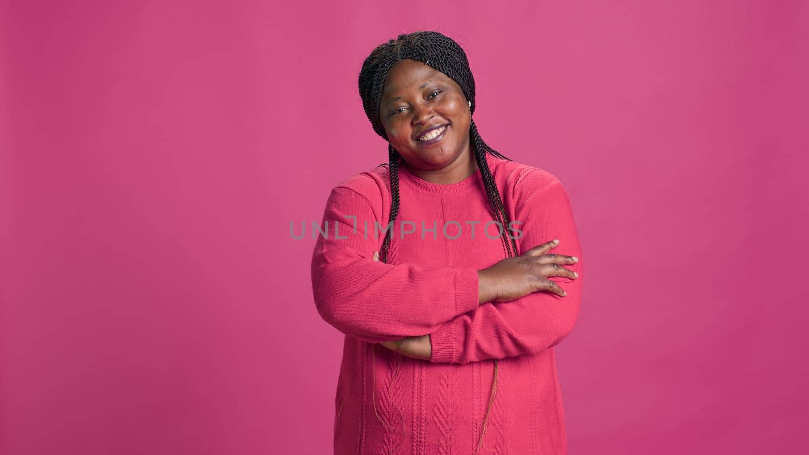 Woman posing against pink background by DCStudio