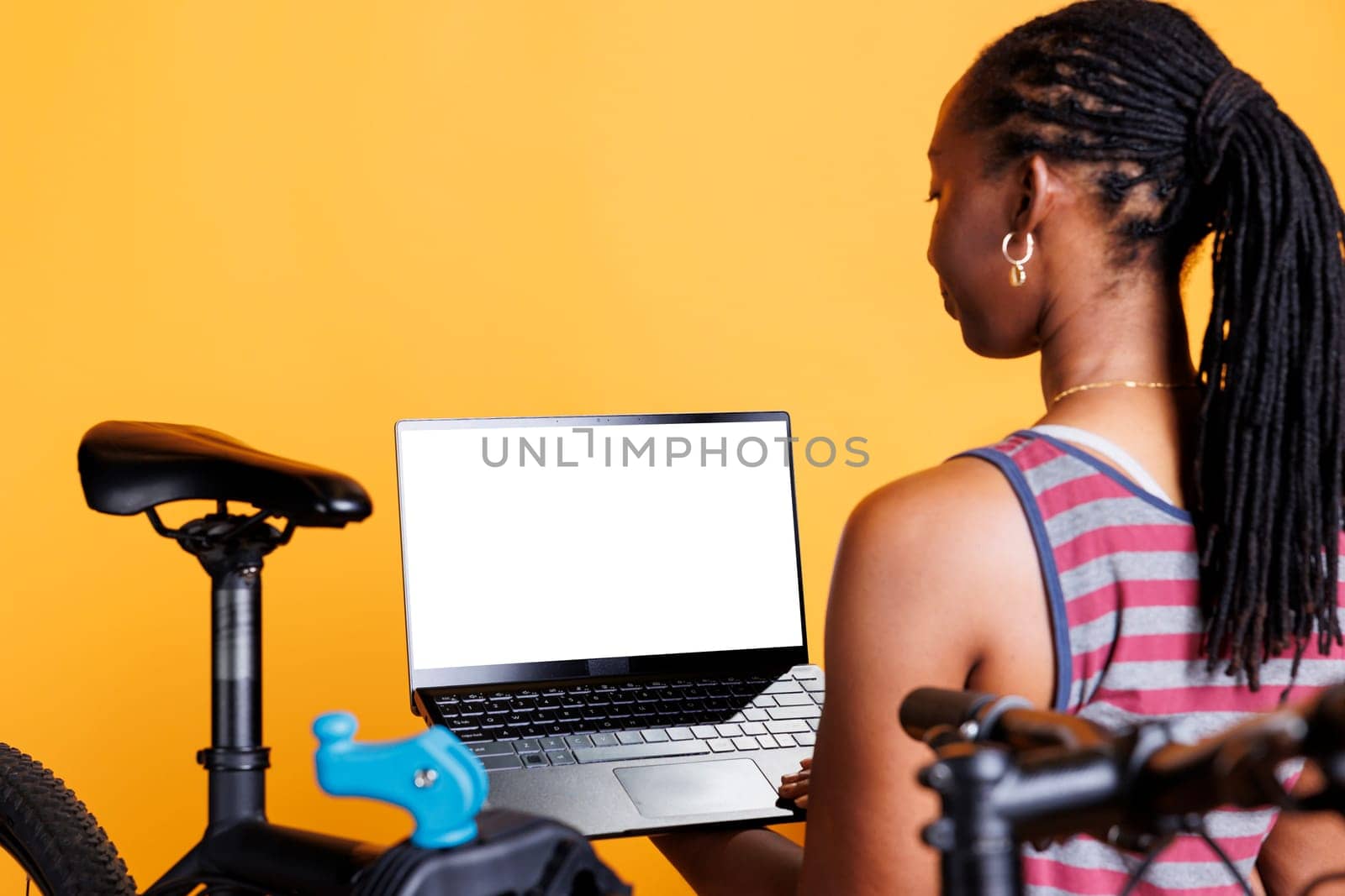 Woman using laptop with whitescreen by DCStudio