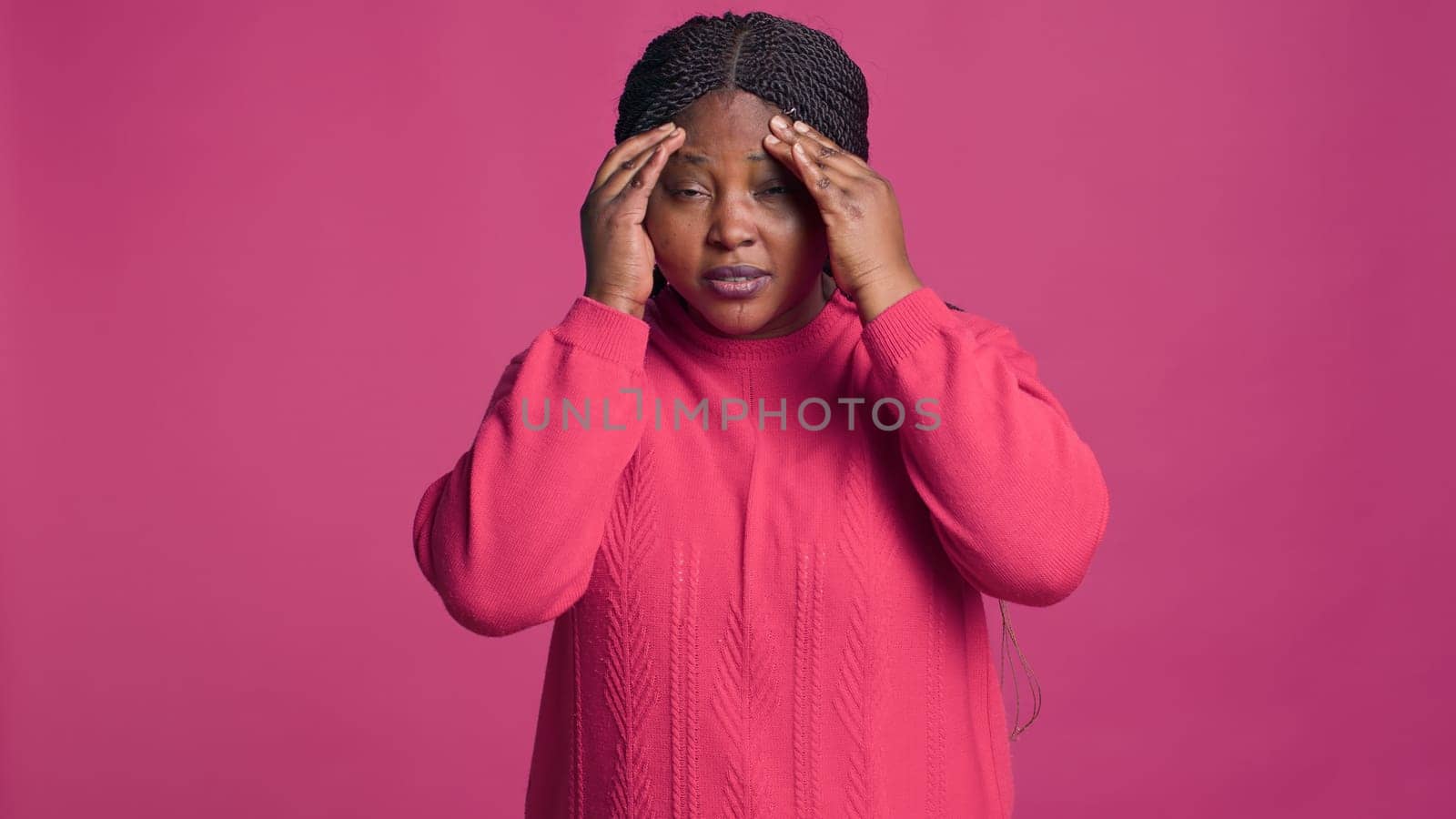 Black woman in sweater having headache by DCStudio