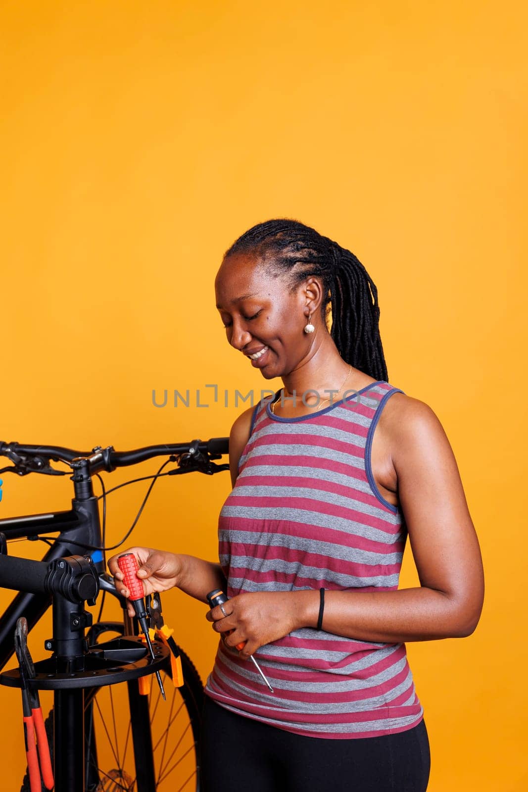 Woman with Bike Tools at Repair Stand by DCStudio