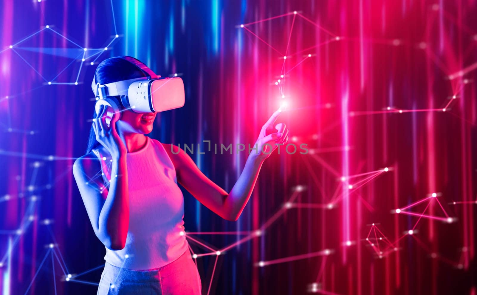 Smart female standing in cyberpunk style building in meta wear VR headset connecting metaverse, future cyberspace community technology, Woman use finger touching virtual reality object. Hallucination.
