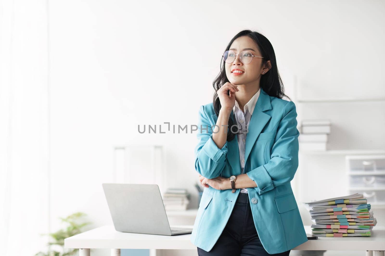 Portrait of young Asian business woman in modern office.