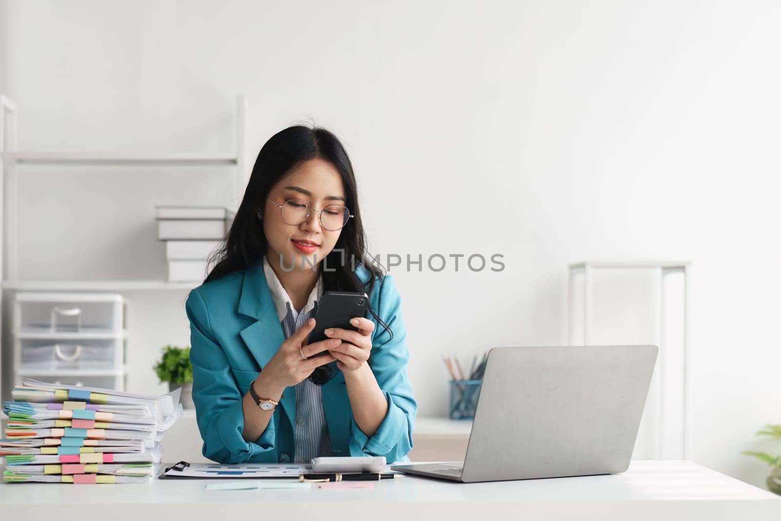 Accounting woman using calculator for budget, tax and loan paper in office by nateemee