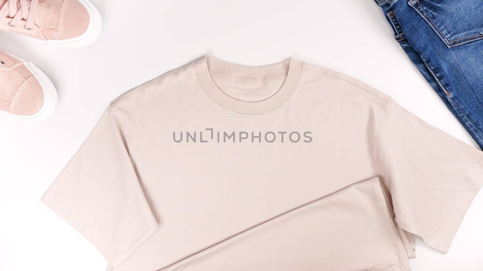Beige unisex t shirt mock up flat lay on white background. Top front view t-shirt, snikers, jeans and copy space. Mockup t-shirt and summertime. Template blank shirt. by JuliaDorian