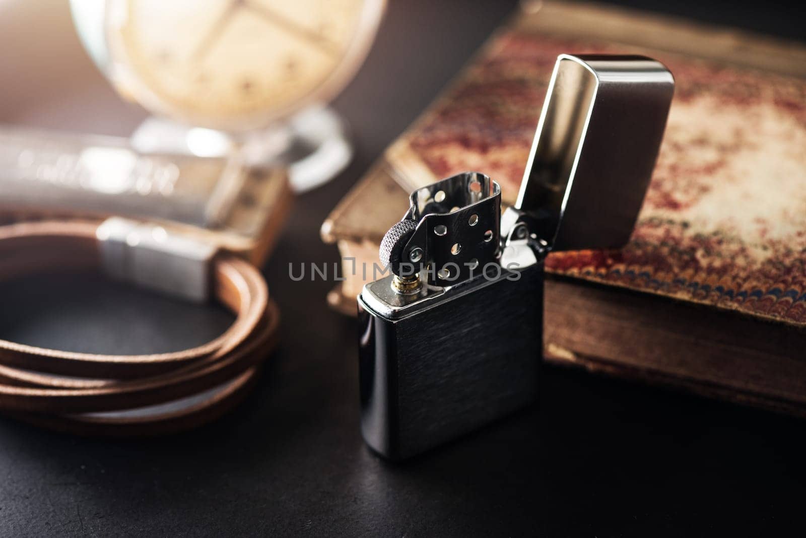 Brushed chrome lighter with windproof. One of everyday carry item for men. Shallow depth of field.