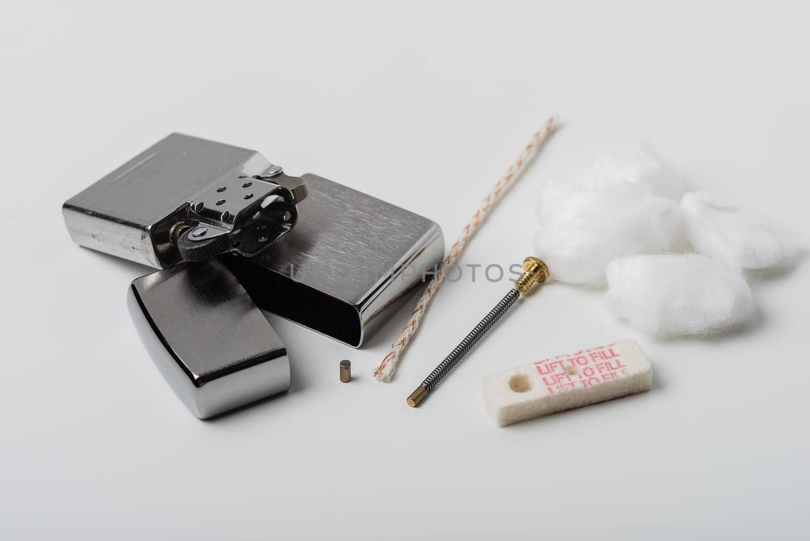 Disassembling of Lighter with windproof over white background.
