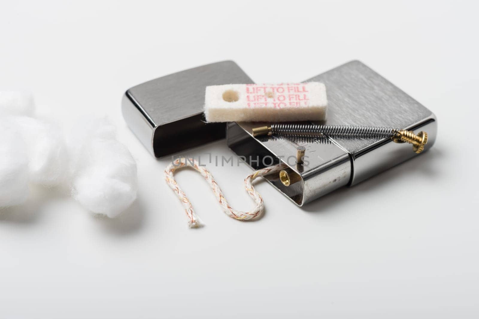 Disassembling of Lighter with windproof over white background.