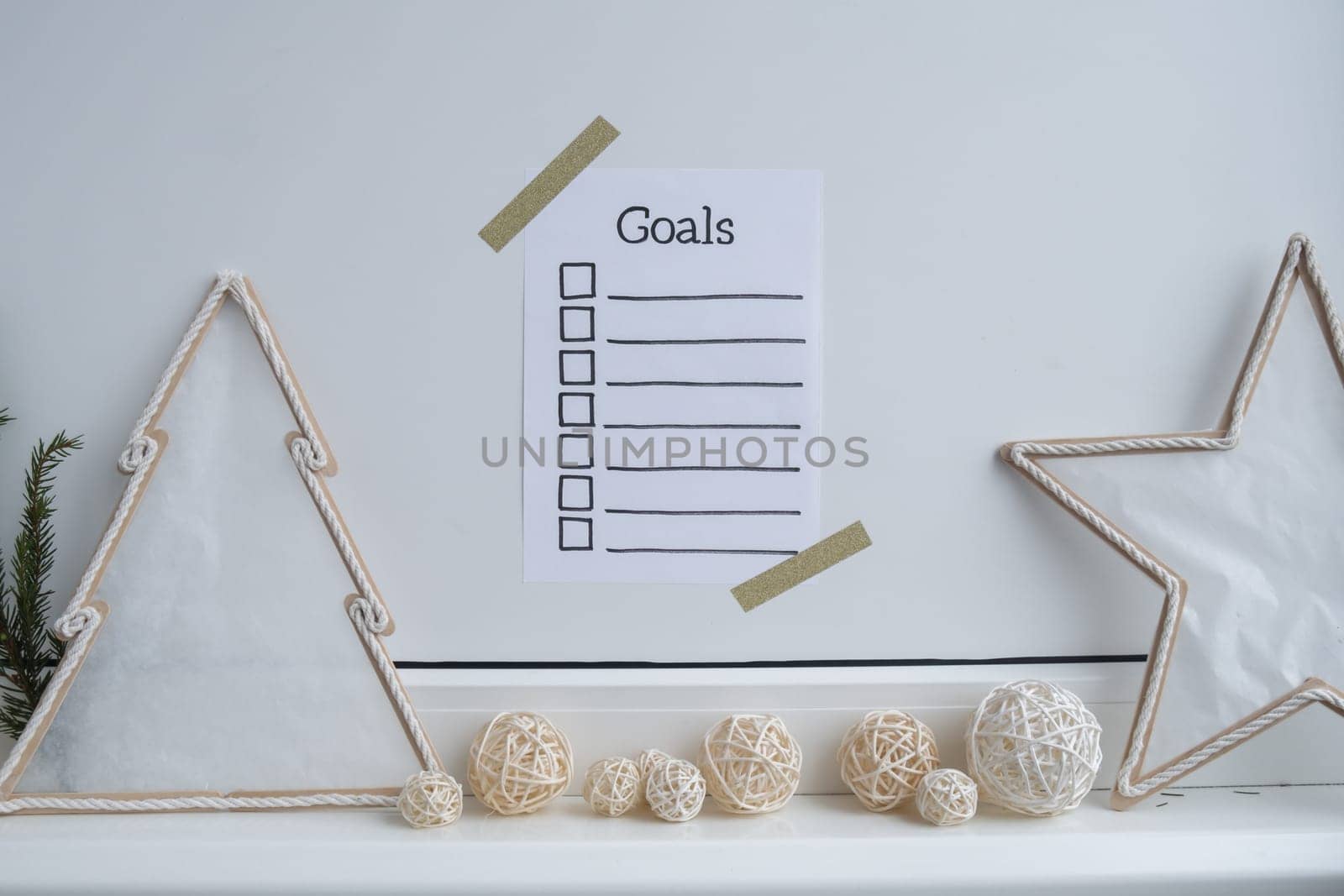 Paper note with inspirational to do checklist GOALS with natural zero waste homemade Christmas decor. Happy new year promises resolutions concept. Self growth and personal development