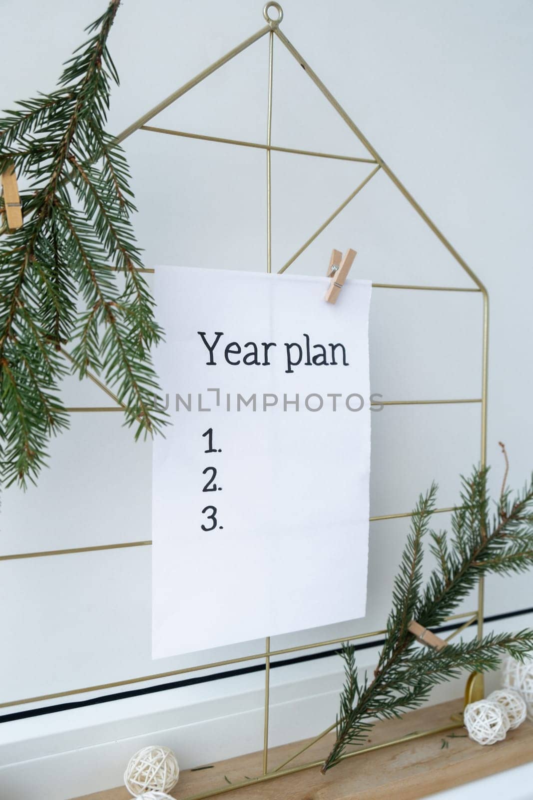 Vision board with YEAR PLAN new year resolutions aims goals on paper note. Preparation for New Year. Planning and setting goals for personal development by anna_stasiia