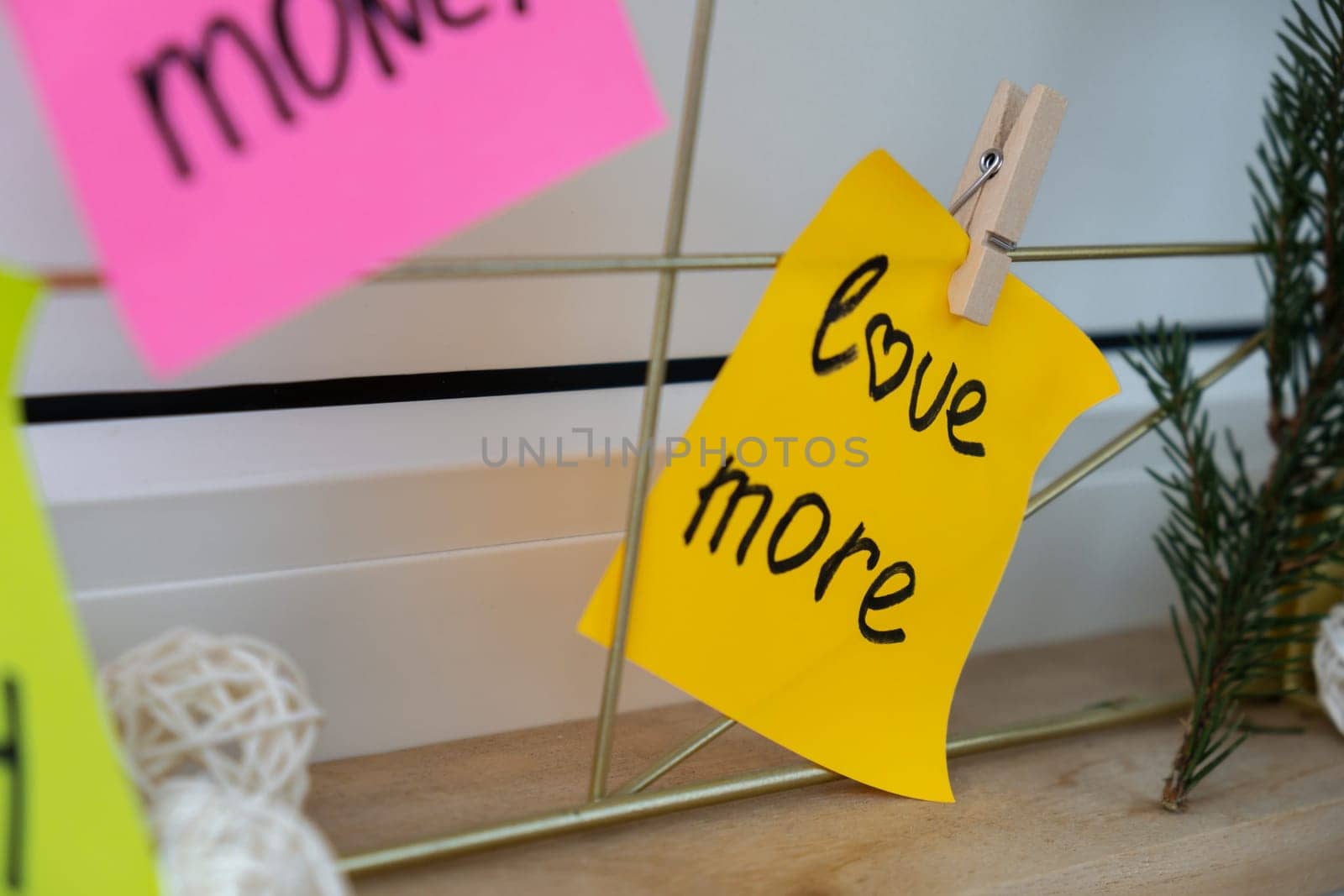 LOVE MORE goal on Vision board with new year resolutions aims on sticky notes. Preparation for New Year. Planning and setting goals for personal development by anna_stasiia