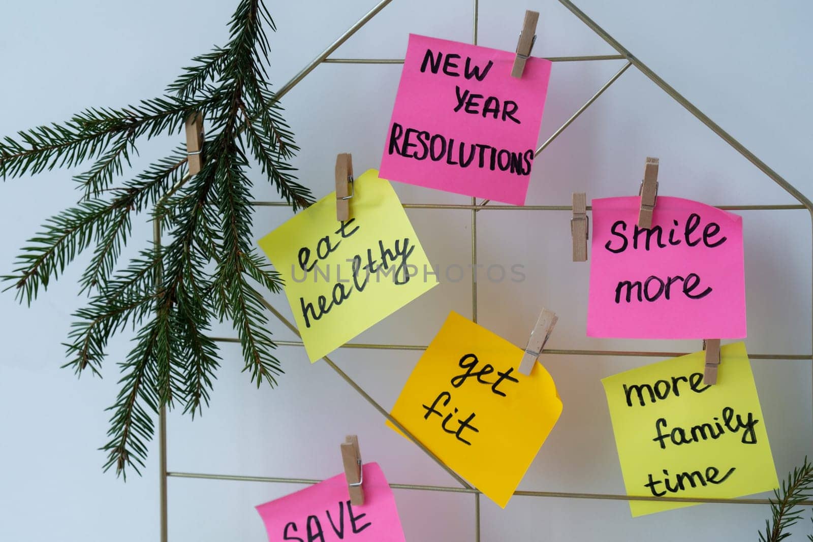 Action board new year's resolutions on colorful sticky notes. Making promises for new year, setting goals. Dream year motivation