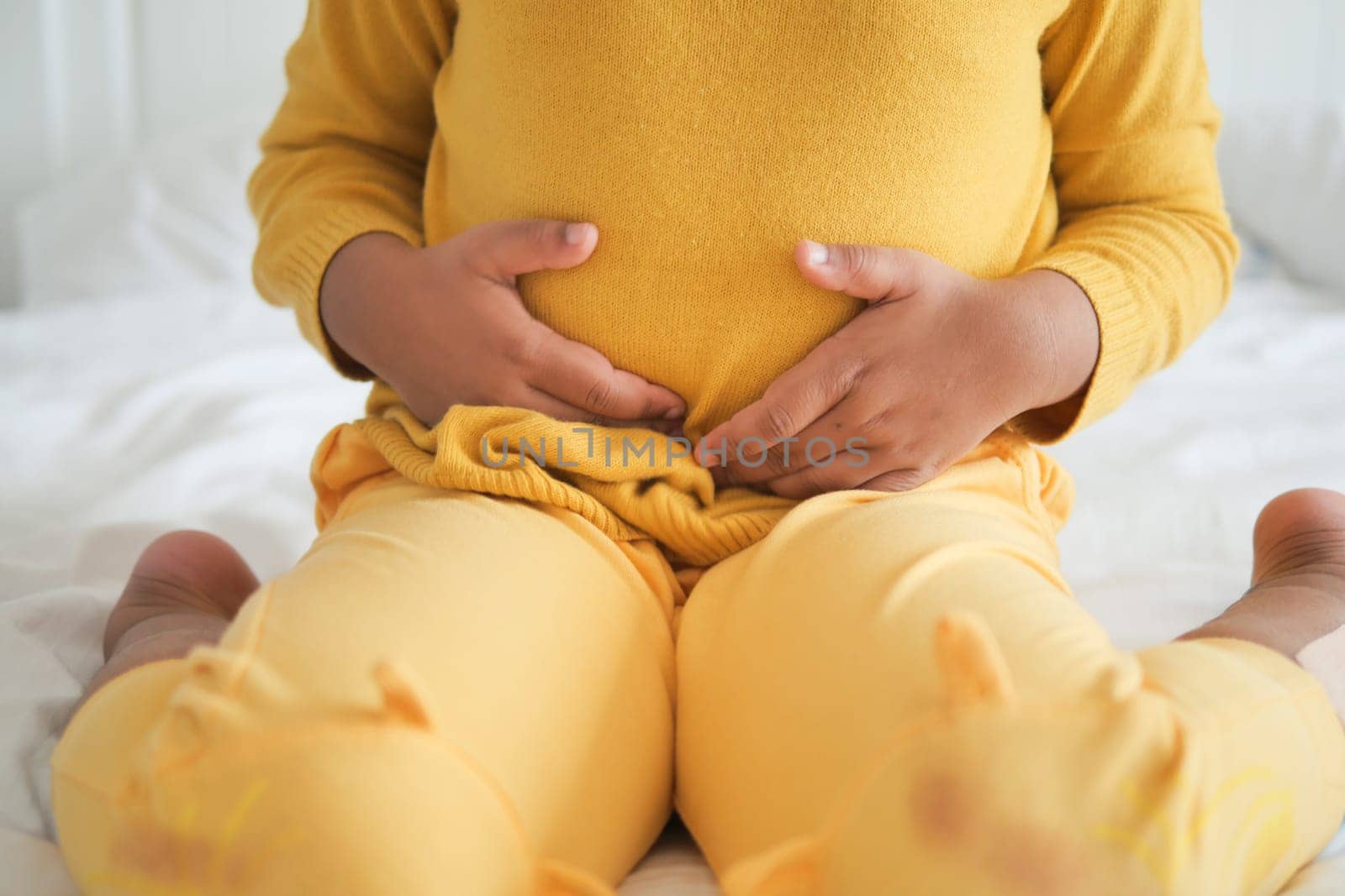 child suffering stomach pain close up..
