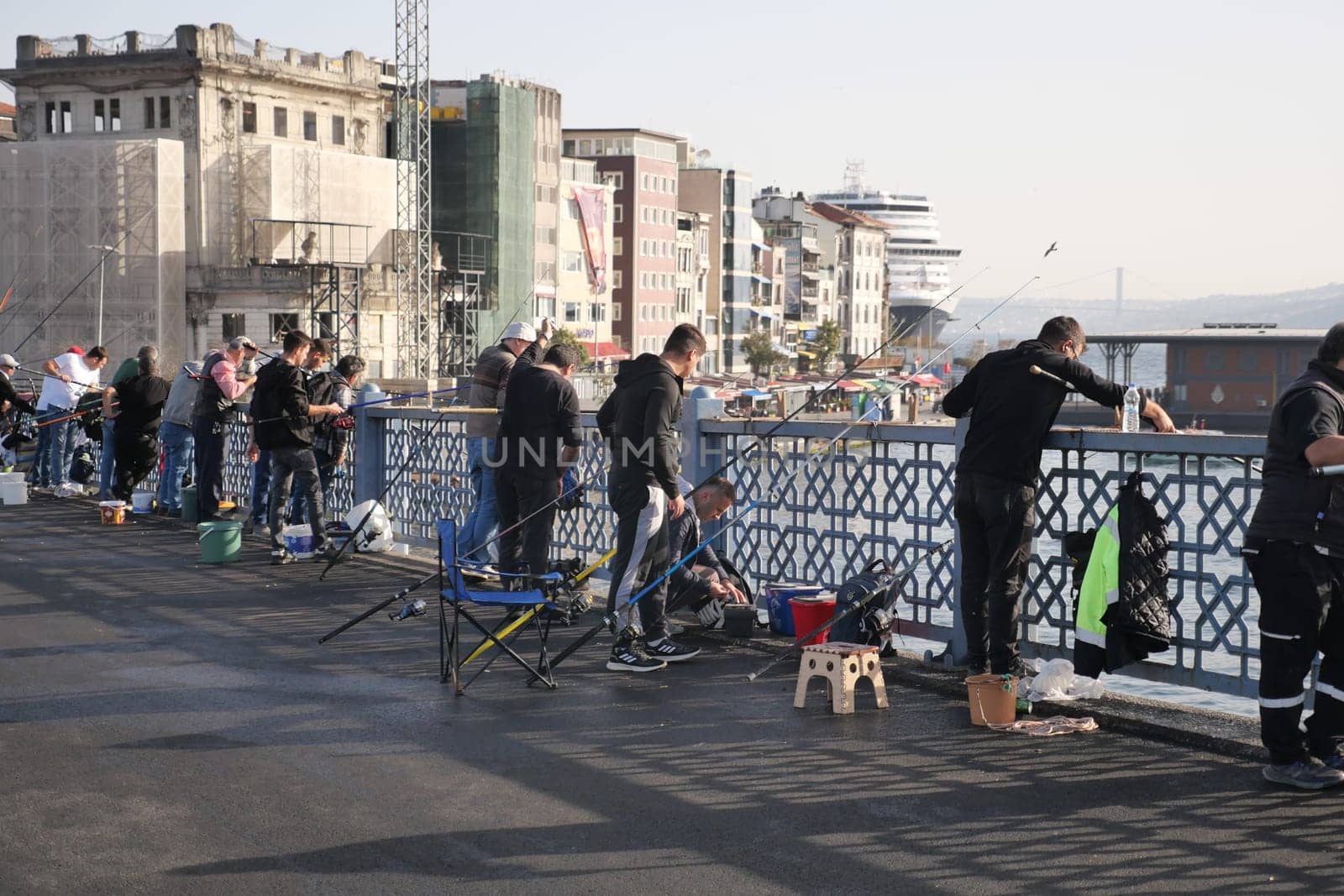 Turkey istanbul 12 january 2024. Fishermen fishing with fishing rods from the Galata Bridge by towfiq007