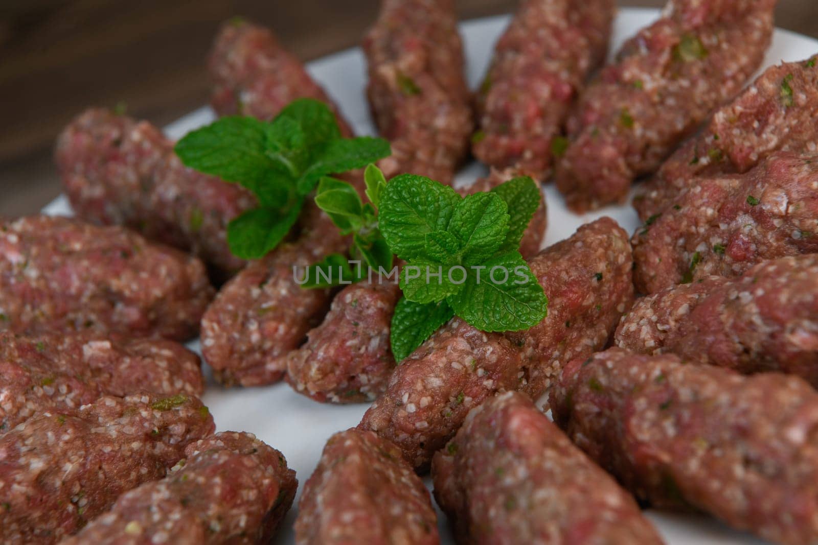 RECIPE FOR LEBANESE KEBBE NAYYHE, RAW MINCED BEEF, MARJORAM, MINT, ONIONS, CRUSHED WHEAT, SEVEN SPICES, CINNAMON, CAYENNE PEPPER. High quality photo