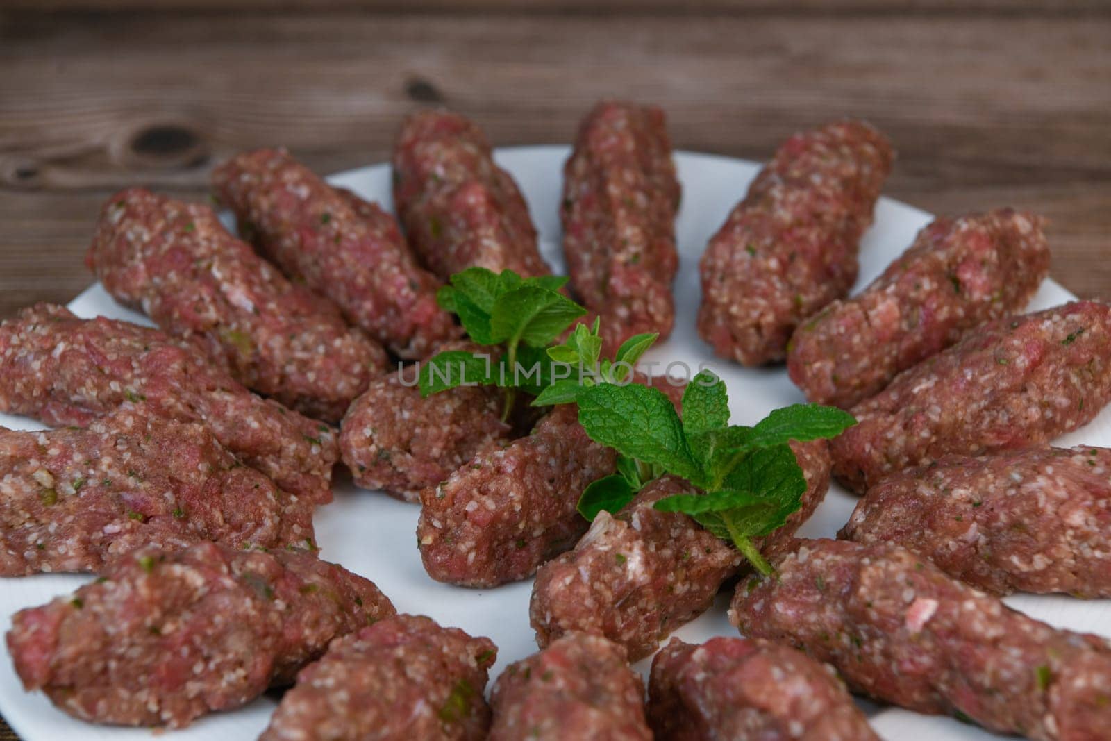 RECIPE FOR LEBANESE KEBBE NAYYHE, RAW MINCED BEEF, MARJORAM, MINT, ONIONS, CRUSHED WHEAT, SEVEN SPICES, CINNAMON, CAYENNE PEPPER. High quality photo