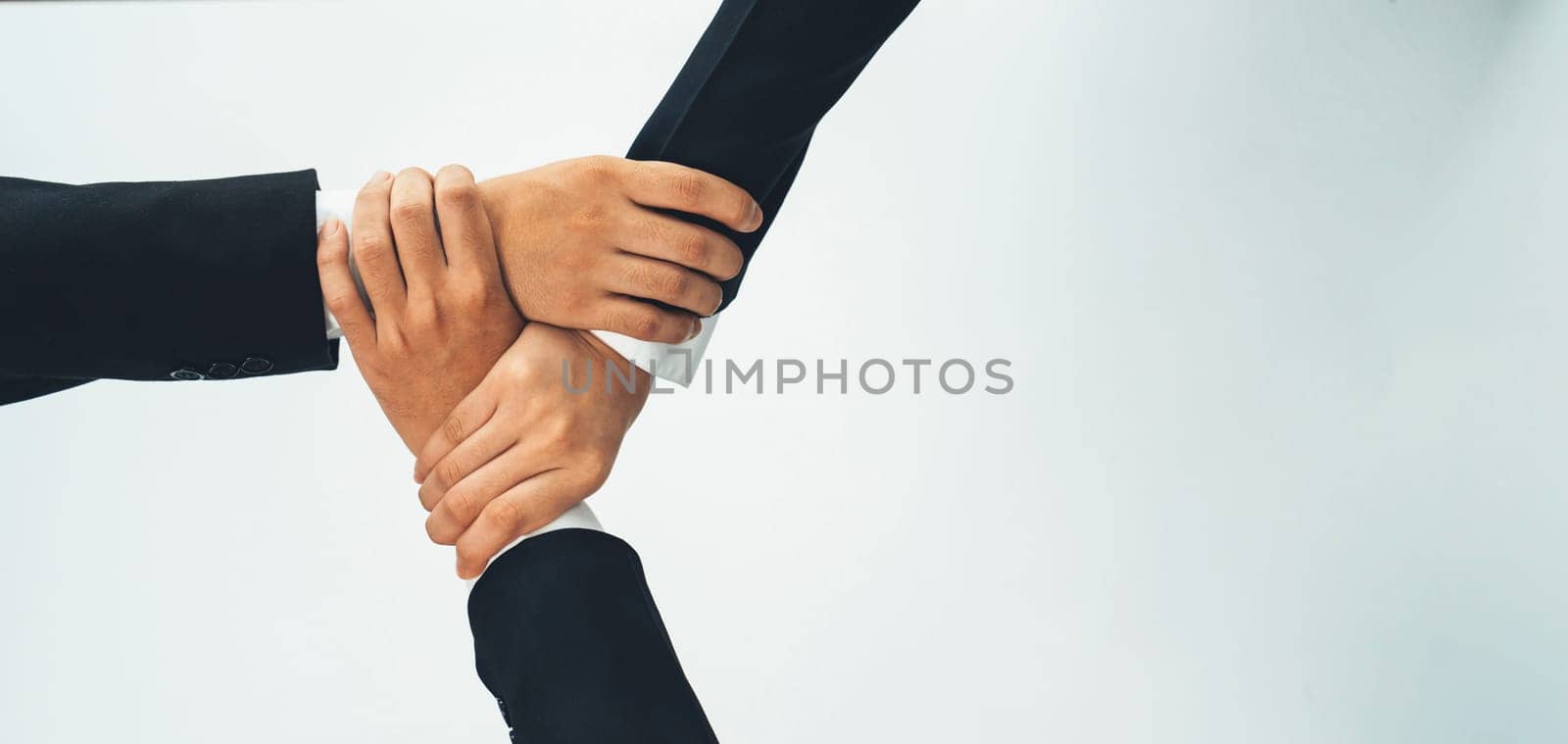 Office worker team stacking hand together symbolize successful group of business partnership and strong collective unity teamwork in community workplace in panoramic banner. Shrewd