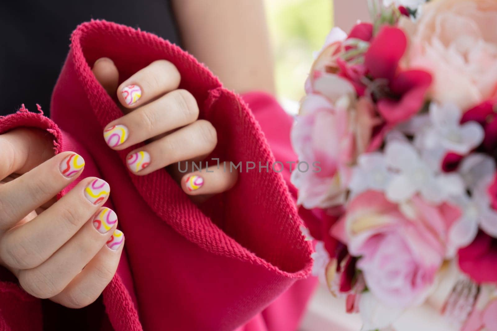 Woman manicured hands, stylish summer colorful nails. Closeup of manicured nails of female hand. Summer style of nail design concept. Beauty treatment.