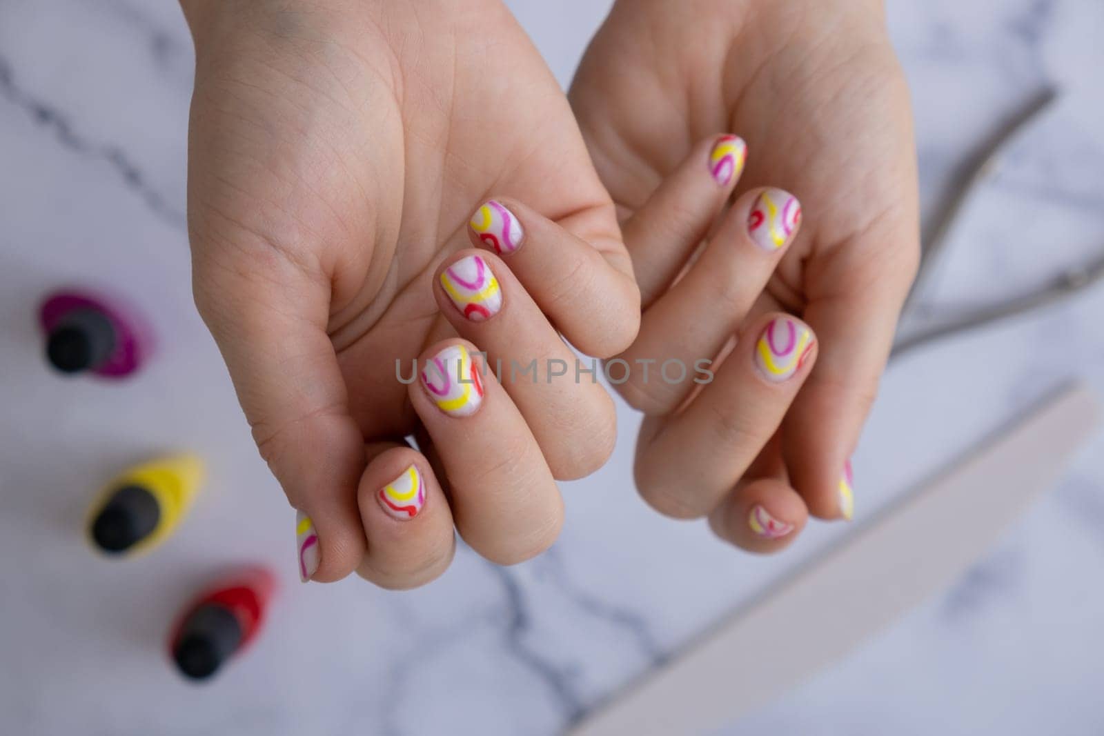 Pastel softness colorful manicured nails. Woman showing her new summer manicure in colors of pastel palette. Simplicity decor fresh spring vibes earth-colored neutral tones by anna_stasiia