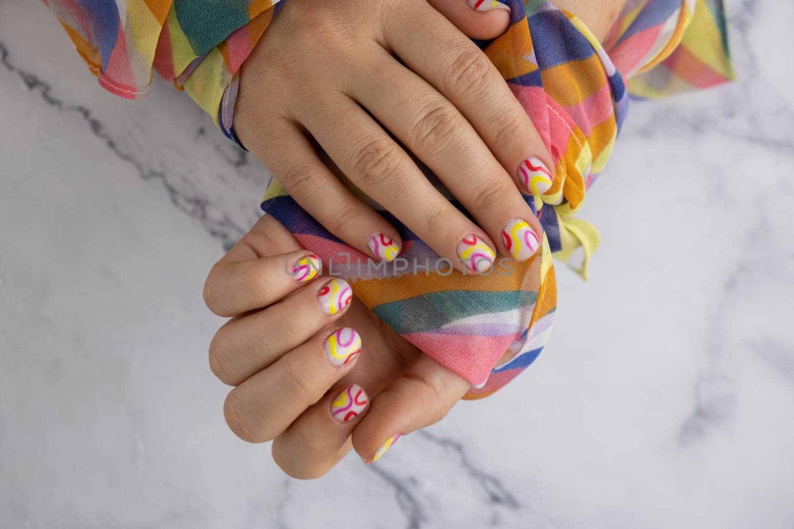 Pastel softness colorful manicured nails. Woman showing her new summer manicure in colors of pastel palette. Simplicity decor fresh spring vibes earth-colored neutral tones by anna_stasiia