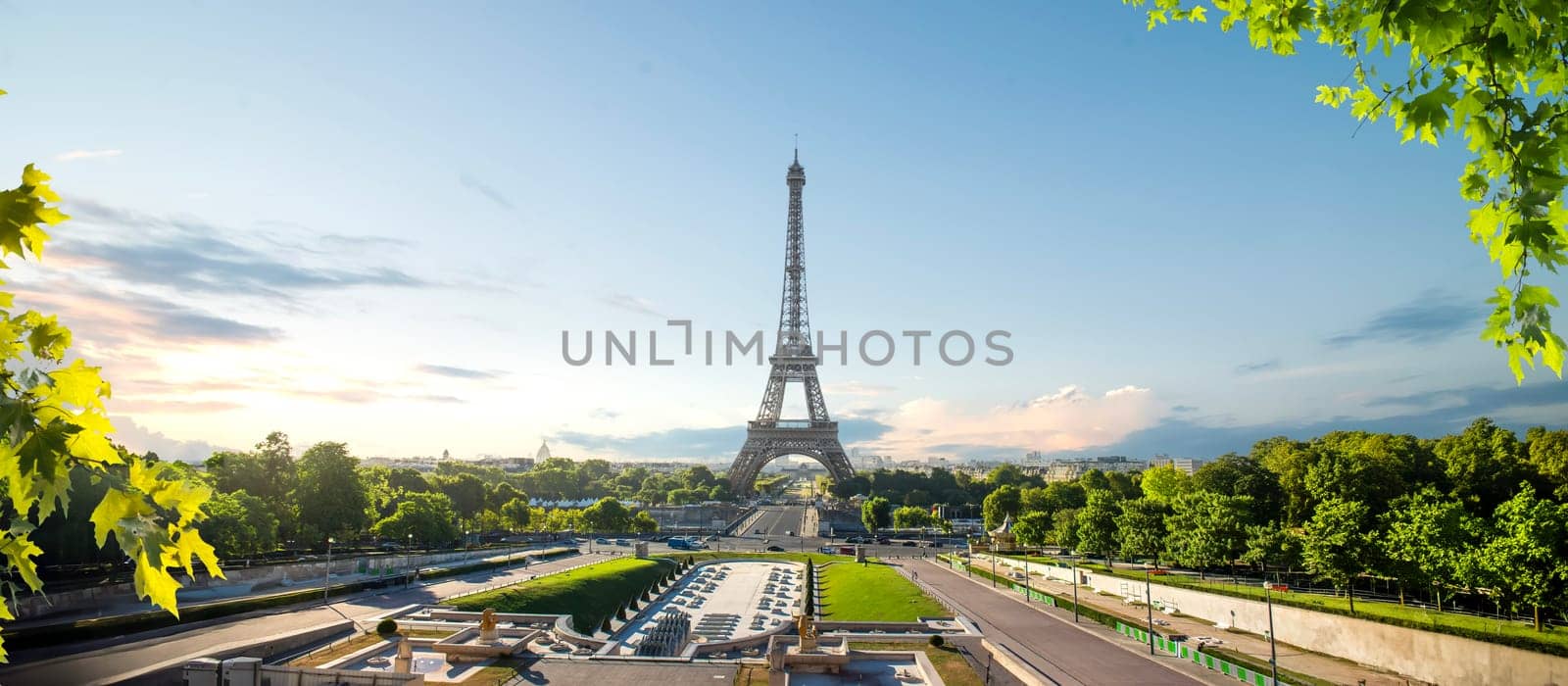 Eiffel Tower and fountains near it at dawn in Paris, France