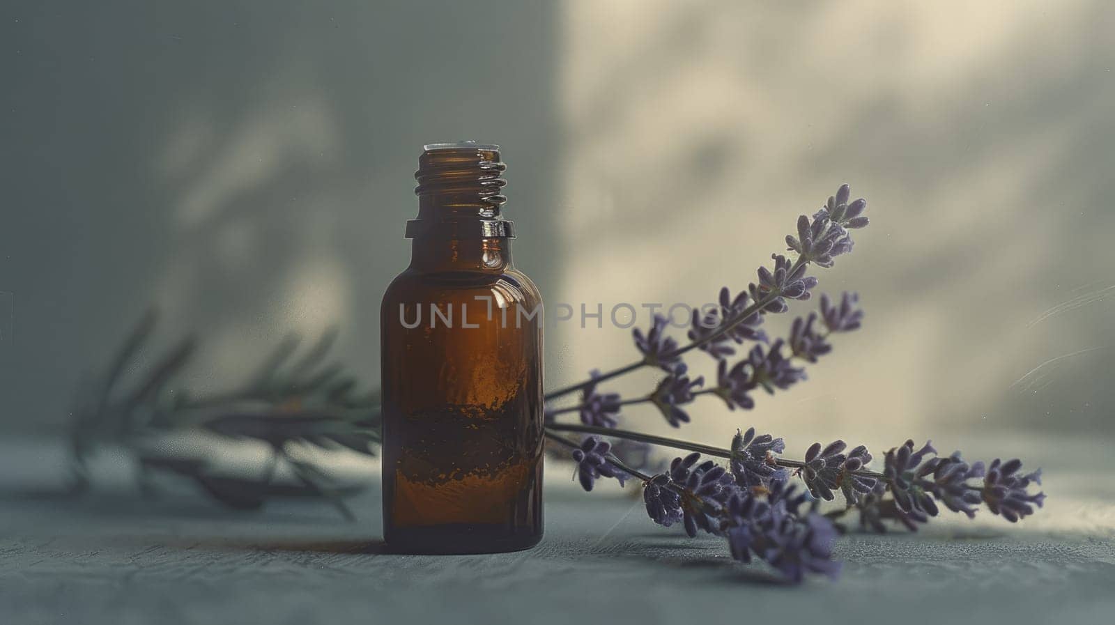 A sleek lavender oil bottle beside a fresh sprig of lavender, Lavender herb and essential aromatherapy oil.
